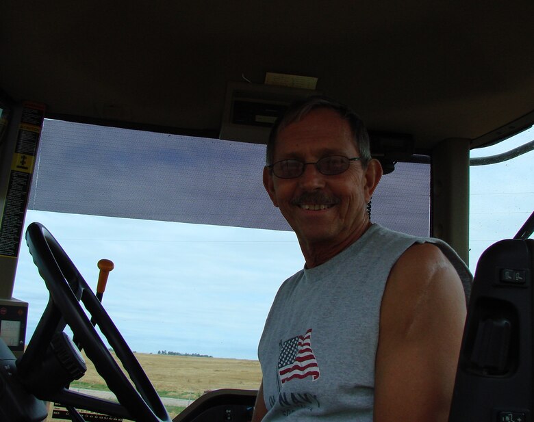 Mayor Kim Ford of Carrier, Okla. harvests his winter wheat crop with the assistance of his wife Goerge Ann and a harvest team from Minnesota. Vance T-38 Talons fly over Carrier as part of routine training missions. (Courtesy photo by George Ann Ford)
