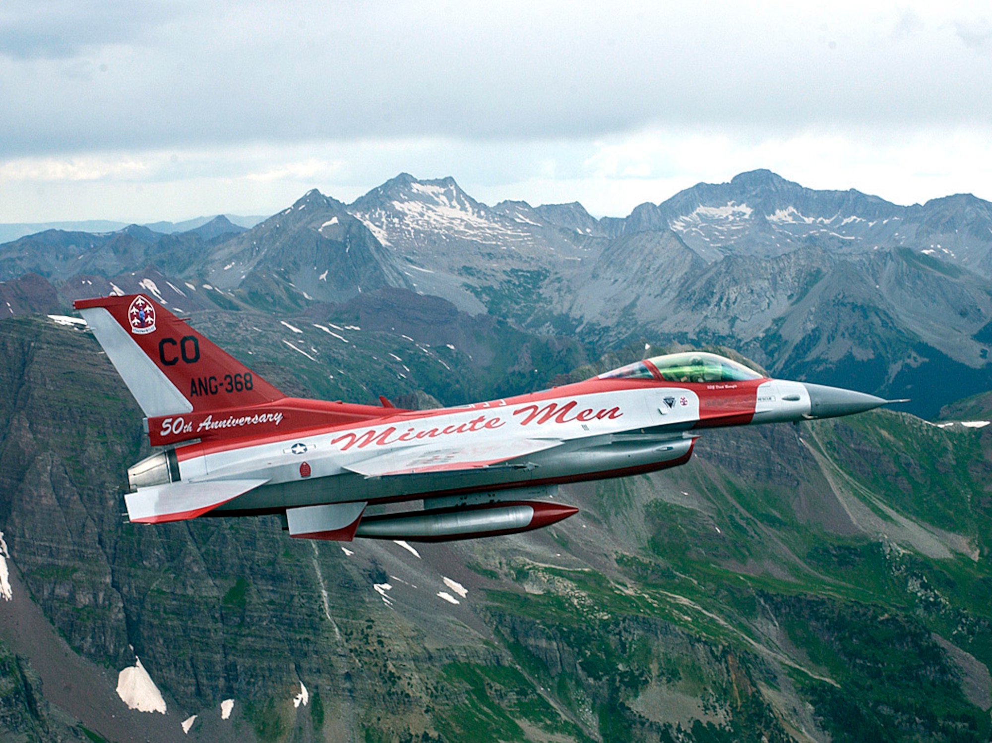 An F-16 aircraft painted in the color scheme of the original Air National Guard flight demonstration team takes flight from the 140th Wing, Buckley Air Force Base, July 26, 2006. This F-16 is flying in the skies above the southern Rocky Mountains.  The 140th Wing of the Colorado Air National Guard has reached the 50th anniversary as the only flying acrobatic Air National Guard team, and to commemorate this event they have painted an F-16 aircraft in the same paint scheme as the original F-86s were 50 years ago. (U.S. Air Force photo by Senior Master Sgt. John Rohrer)                             