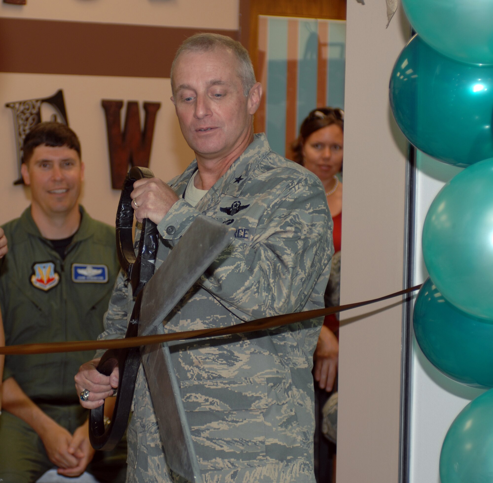 WHITEMAN AIR FORCE BASE, Mo. -509th Bomb Wing Commander Brig. Gen. Garrett Harencak cuts the ribbon for the grand opening of the True Brew coffee shop located in the base exchange July 1. (U.S. Air Force photo/Staff Sgt Charles D. Larkin Sr.)                                           