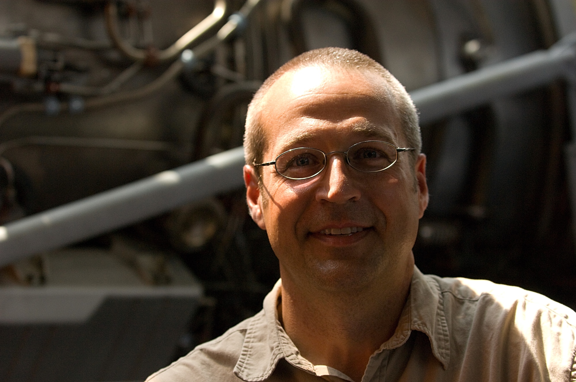 LANGLEY AIR FORCE BASE, Va. -- Allen Hoilman, Virginia Air and Space Center curator and director of exhibits and collections, stands in front of an F100-100 jet engine on exhibit the center June 27.   (U.S. Air Force photo/Staff Sgt. Barry Loo)