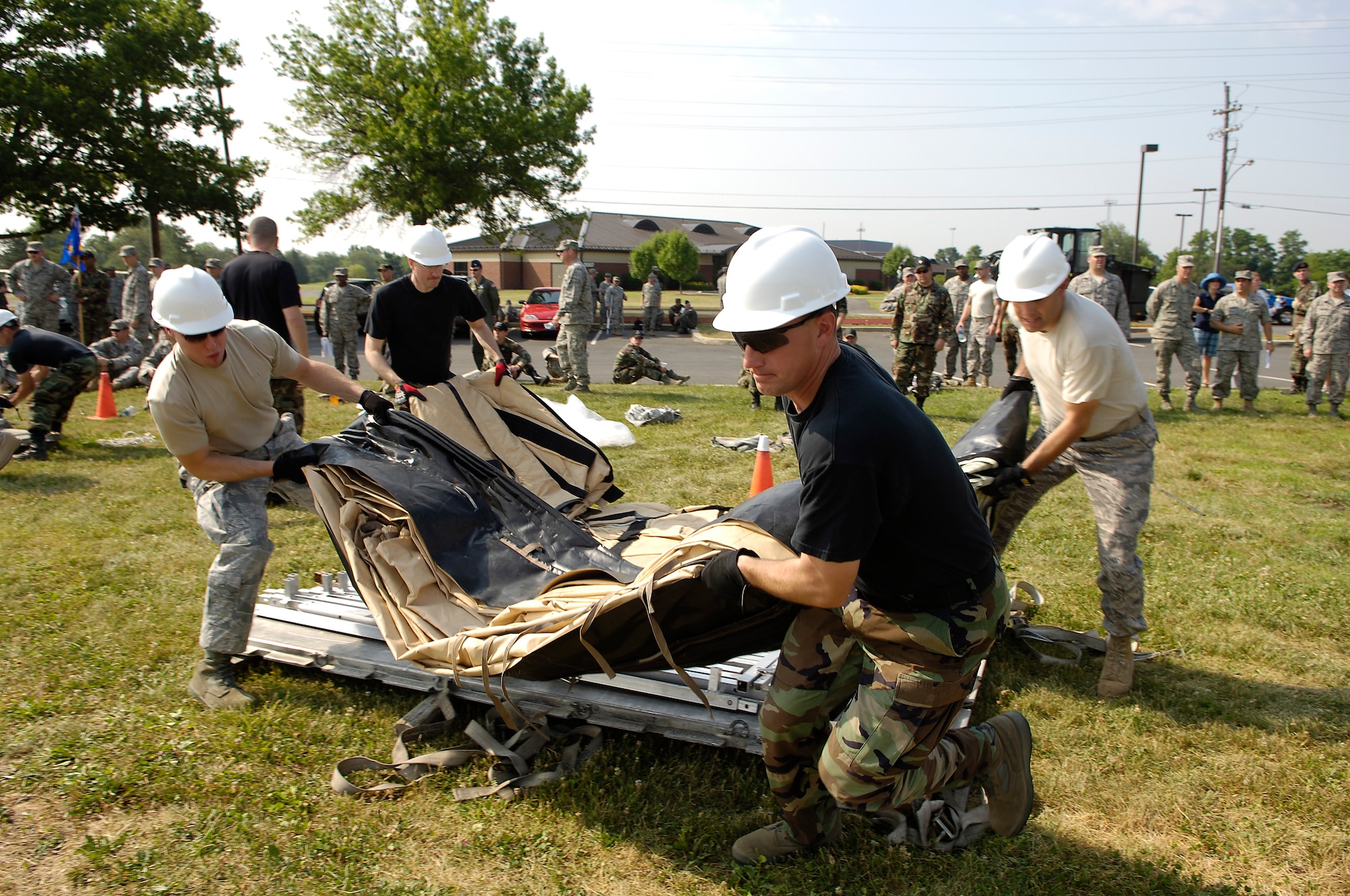 Members from the 816th Contingency Response Group unpack a tent during the Alaskan tent building event as part of the 621st Contingency Response Wing Combat Field Day June 27 here. The field day consisted of numerous events, including the ruck-sack relay, tent building and an obstacle course. (U.S. Air Force photo/Kenn Mann)