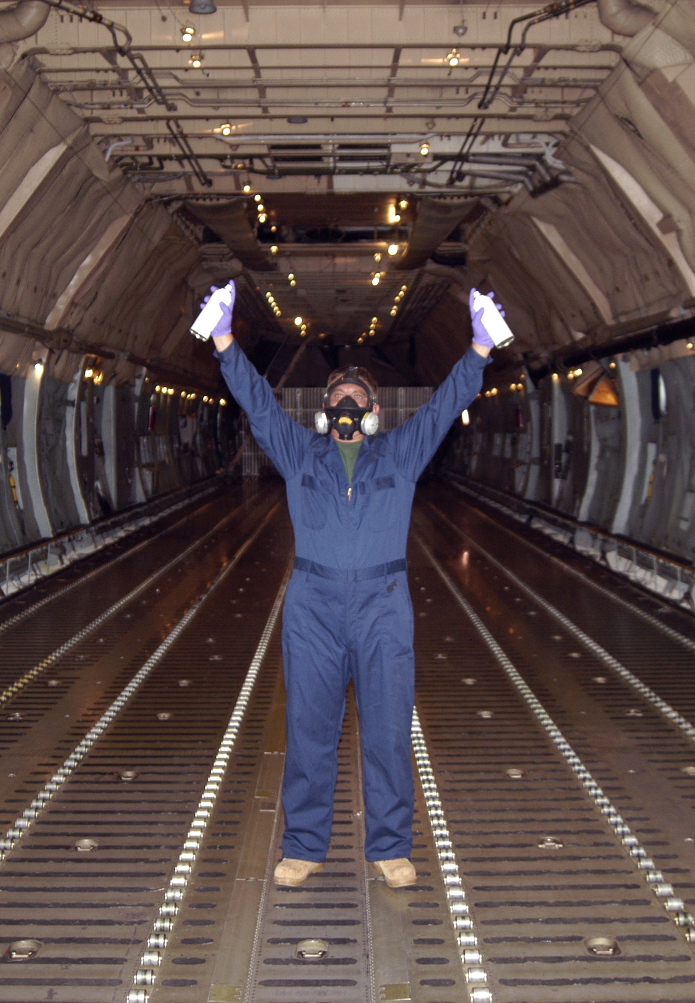 DOVER AIR FORCE BASE, Del. -- Ken Barnes, 436th Civil Engineer Squadron pest management technician, prepares to debug a C-5 Galaxy June 30 here. All military and civilian aircraft leaving DAFB and travel to one of nine quarantined states west of the Rocky Mountains must be debugged by entomologists before it can fly. The measures, enforce by the U.S. Department of Agriculture, stop the artificial spread of the Japanese beetle which could devastate crops in California and other western states. (U.S. Air Force photo/Senior Airman James Bolinger)