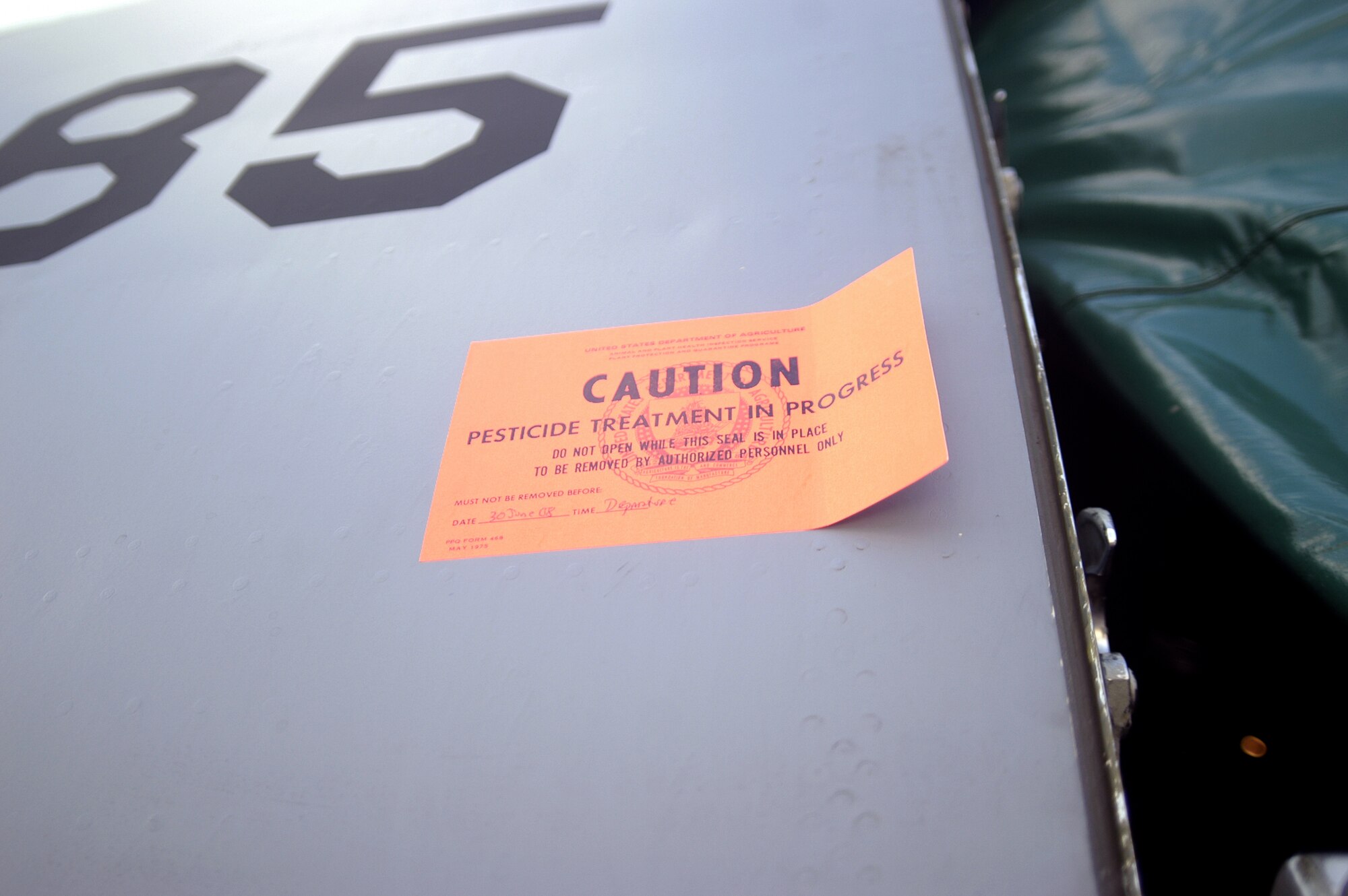 DOVER AIR FORCE BASE, Del. -- A C-5 Galaxy is treated for Japanese beetles June 30 here. All military and civilian aircraft leaving DAFB and traveling to one of nine quarantined states west of the rockies must be debugged by entemologists before it can fly. The measures, enforce by the U.S. Department of Argiculture, stop the artificial spread of the Japanese beetle which could devaste crops in California and other western states. (U.S. Air Force photo/Senior Airman James Bolinger)