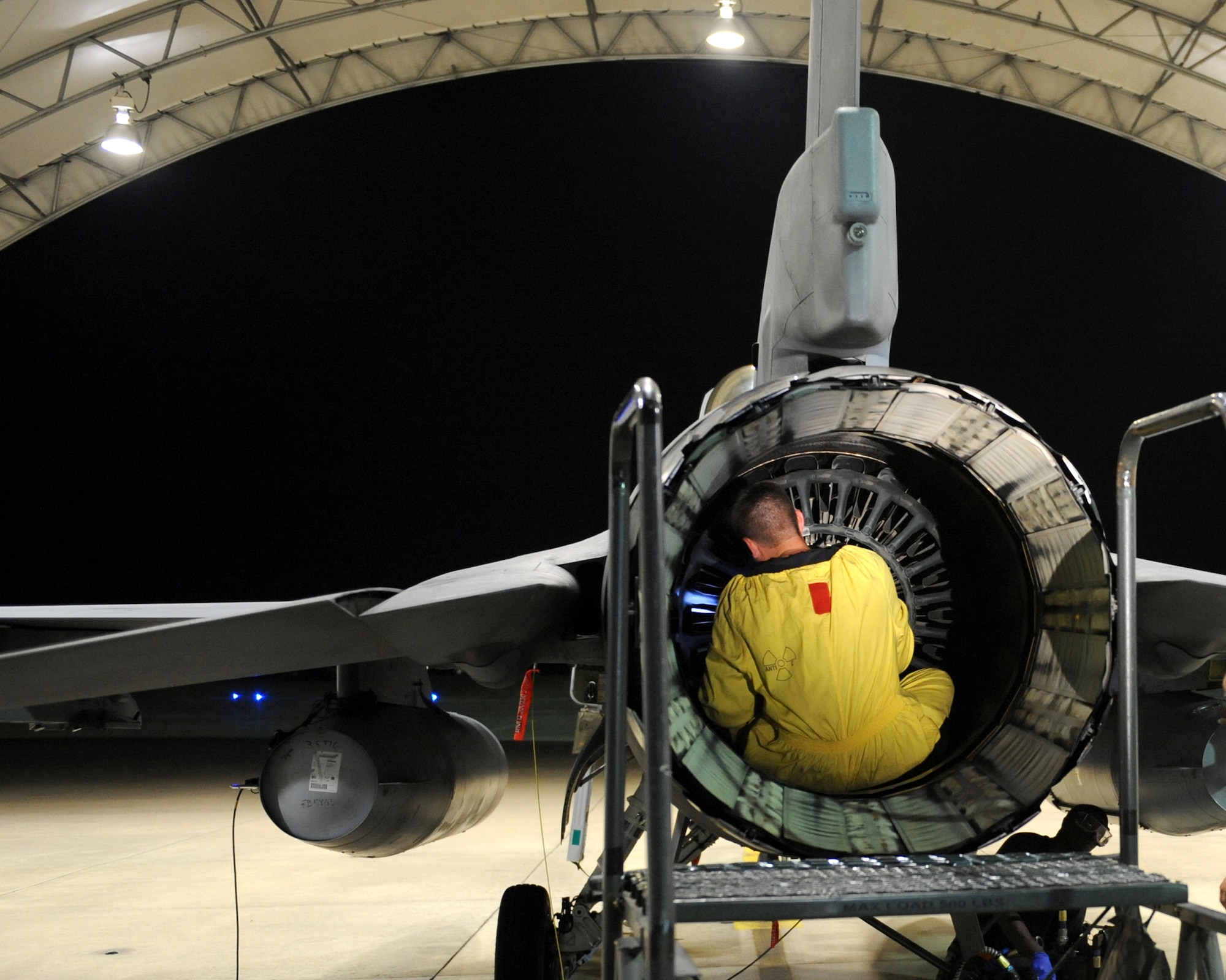 SHAW AIR FORCE BASE, SC - A crew chief from the 20th Fighter Wing inspects the exhaust of an F-16 fighter jet, a mere 7 minutes after engine shutdown to ensure the quickest return to ready status during a training mission marking the 50,000th sortie flown in support of Operation Noble Eagle June 30. The ONE mission is to protect the homeland from air threats, and if necessary, eliminate threats that endanger the public or critical infrastructure in the United States. (U.S. Air Force photo/Staff Sgt Henry Hoegen)
