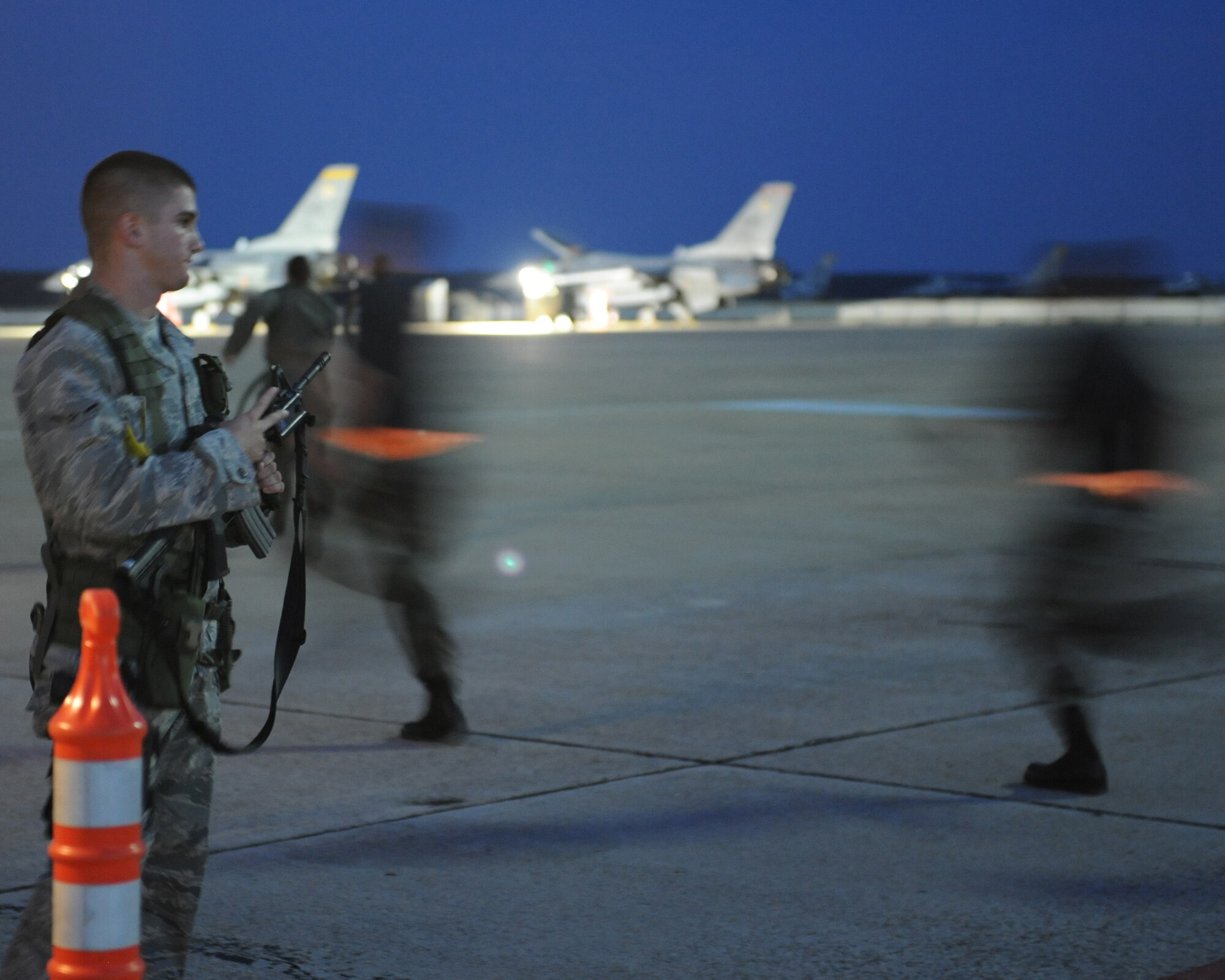 SHAW AIR FORCE BASE, SC - Aircraft support personnel supporting Operation Noble Eagle show Airman  Adam Bohl, 20th Security Forces Squadron, the flight line entry security code as they rush out to the F-16 fighter jets during a training mission marking the 50,000th sortie flown June 30. The ONE mission is to protect the homeland from air threats, and if necessary, eliminate threats that endanger the public or critical infrastructure in the United States. (U.S. Air Force photo/Staff Sgt Henry Hoegen)