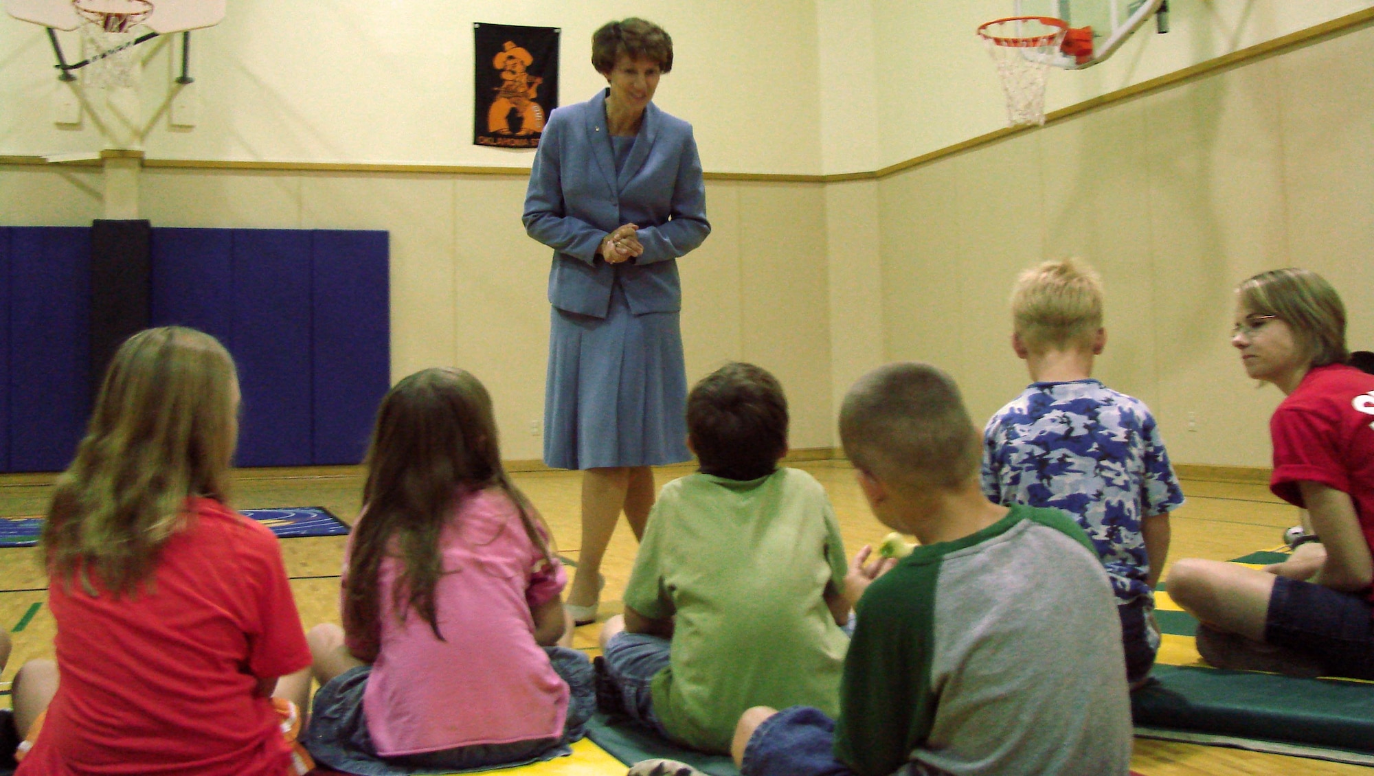 Retired Air Force Col. Eileen Collins, a former astronaut from NASA and a 1979 first assignment instructor pilot at Vance AFB, Okla. visits the Youth Center and describes the feeling of weightlessness to a group of youth.  (U.S. Air Force photo by Joe Wiles)