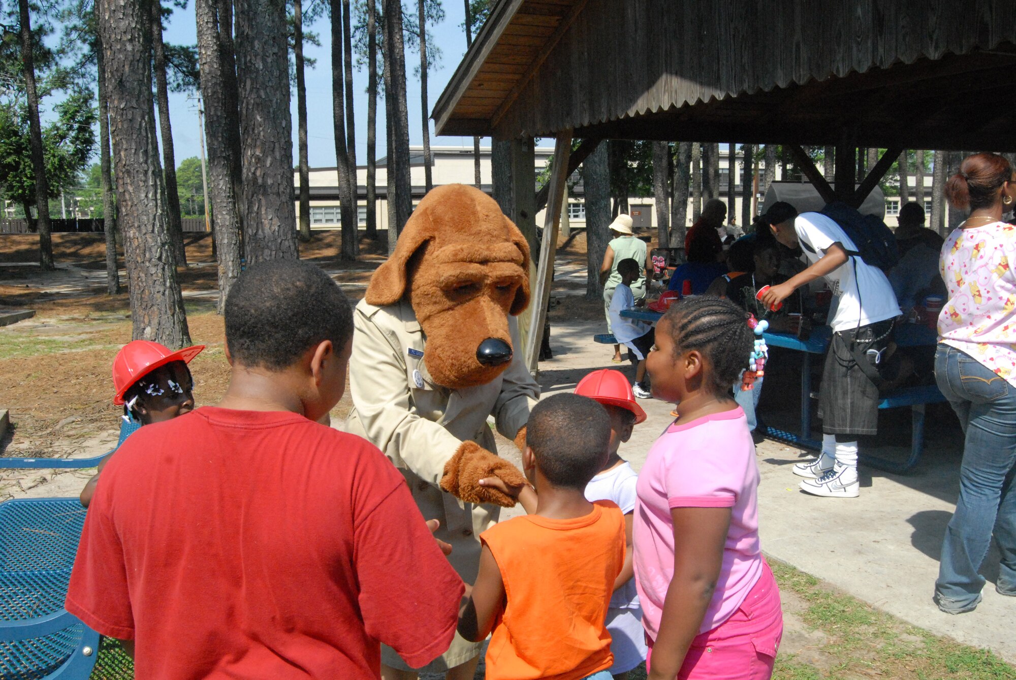 McGriff the Crime Dog greet kids at Woodland Park during the June 25 picnic for Cumberland County foster children and their families hosted by 43rd Security Forces Squadron and North Carolina Department of Social Services. (U.S. Air Force Photo by Emily Smith)