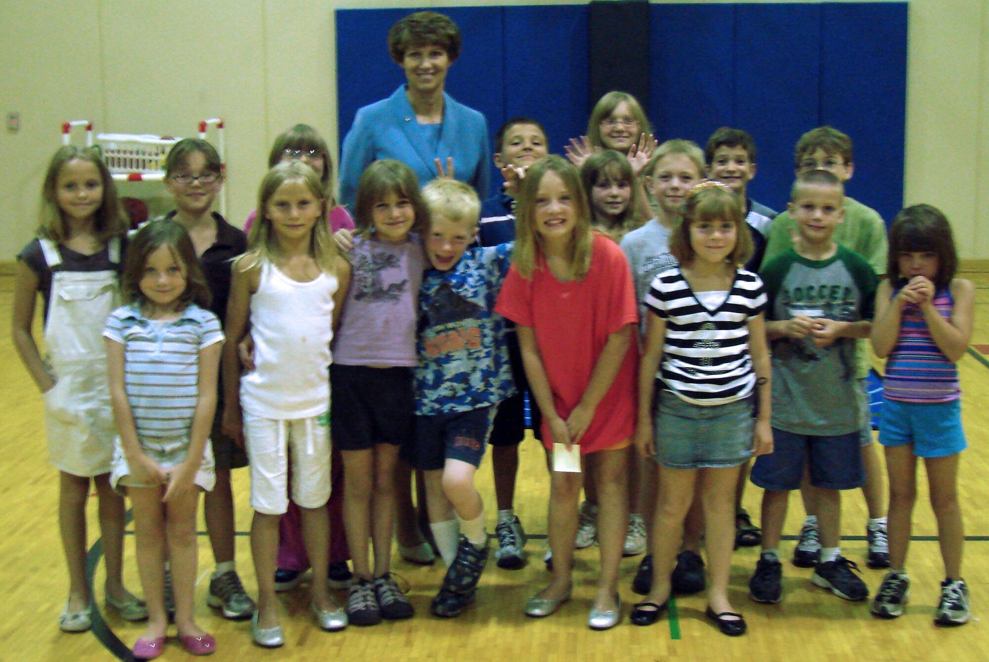 Retired Air Force Col. Eileen Collins, a former astronaut from NASA and a 1979 first assignment instructor pilot at Vance AFB, Okla. takes a picture with the youth before concluding her visit there.  (U.S. Air Force photo by Joe Wiles)
