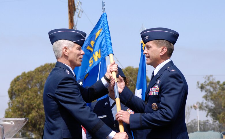 VANDENBERG AIR FORCE BASE, Calif. --  Lt. Gen. William Shelton, 14th Air Force commander (left), hands the guidon to Col. David Buck, 30th Space Wing commander, at a change of command ceremony here Friday. This ceremonial practice represents Colonel Buck's taking over command here. Colonel Buck is the former vice commander of the 50th Space Wing. (U.S. Air Force photo/Airman 1st Class Jonathan Olds)