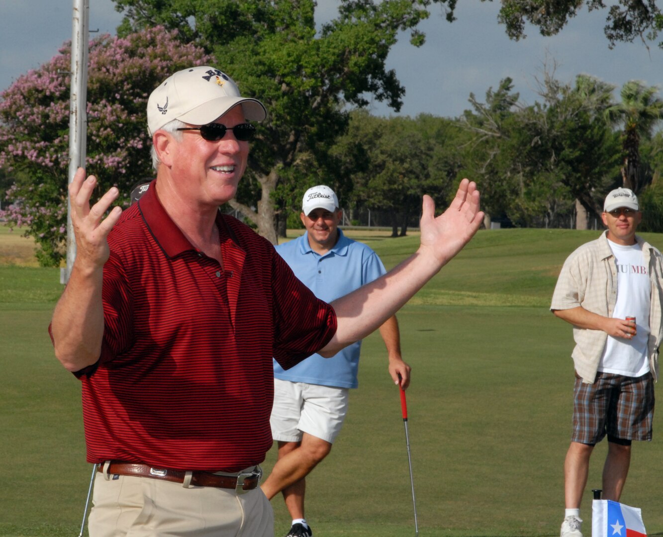 Gen. William Looney, Commander, Air Education and Training Command, shares his last official golf story of "the putt that got away" with onlookers before teeing off during his farewell golf tournament June 27. Base officials banded together to send off General Looney in an unusual tournament with no scorecards and no winner; the day was "just for fun."