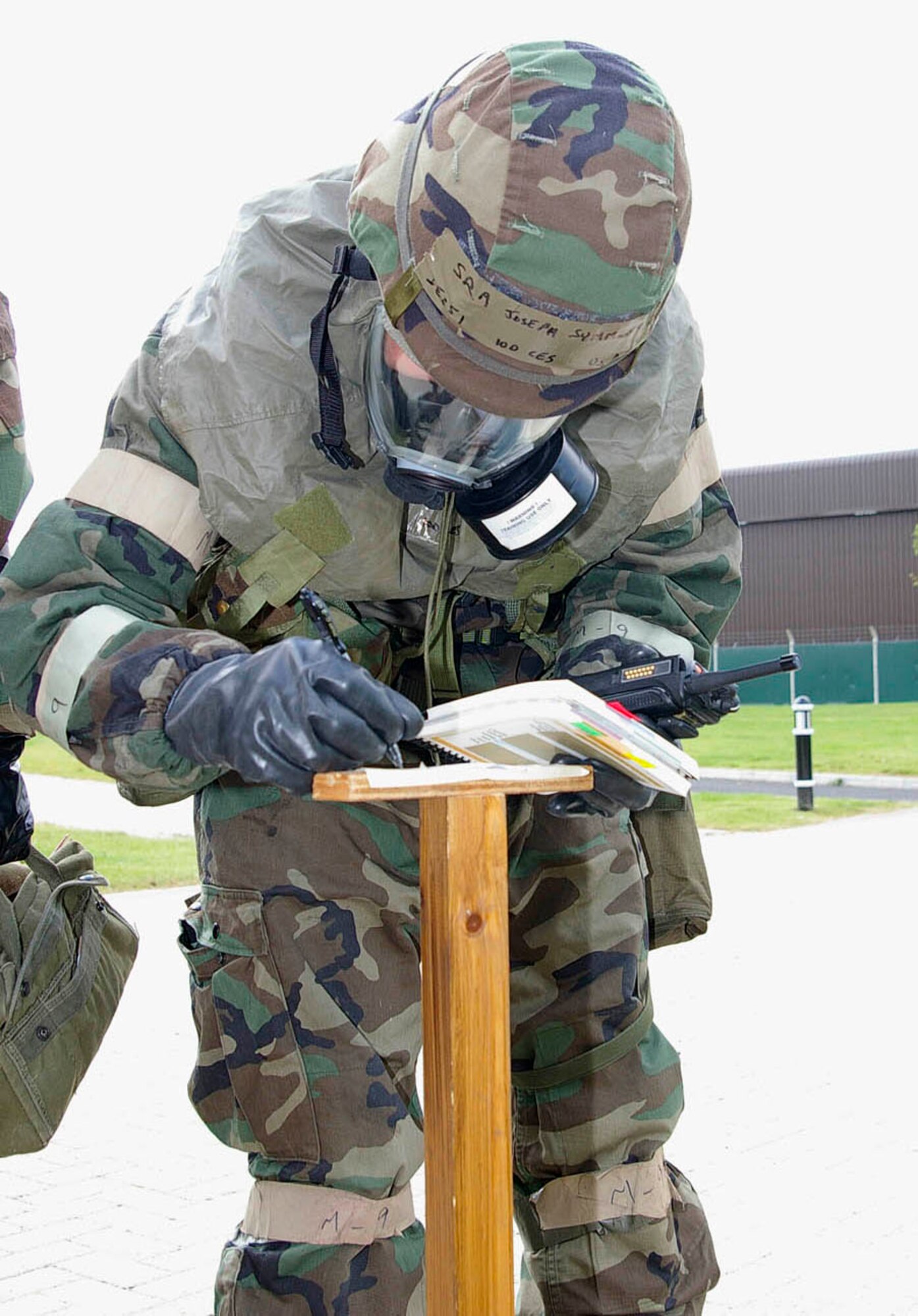 Senior Airman Joseph Symmonds, 100th Civil Engineer Squadron post attack reconnaissance team member checks one of the simulated liquid agent detection points to to note any changes on simulated M8 paper during an exercise June 25. RAF Mildenhall conducted a base-wide Phase II exercise June 24 to 26 to better prepare Airmen for deployments and wartime environments and to train for the upcoming operational readiness inspection in 2009. (U.S. Air Force photo by Karen Abeyasekere)
