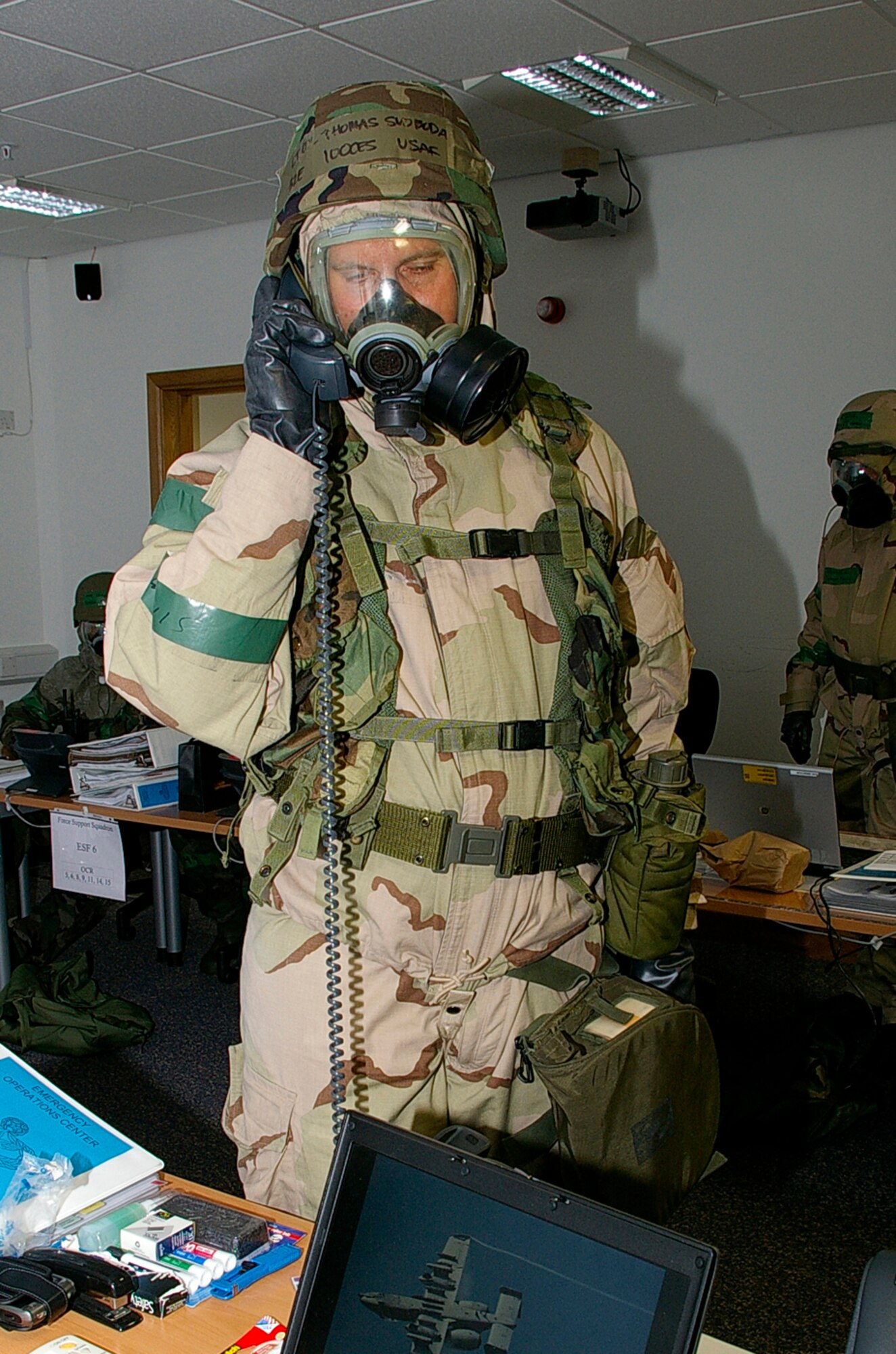 Lt. Col. Thomas Svoboda, 100th Civil Engineer Squadron commander, gives an initial release for Alarm Black, MOPP 4 at the emergency operations center during an exercise June 25. RAF Mildenhall conducted a base-wide Phase II exercise June 24 to 26 to better prepare Airmen for deployments and wartime environments and to train for the upcoming operational readiness inspection in 2009. (U.S. Air Force photo by Karen Abeyasekere)
