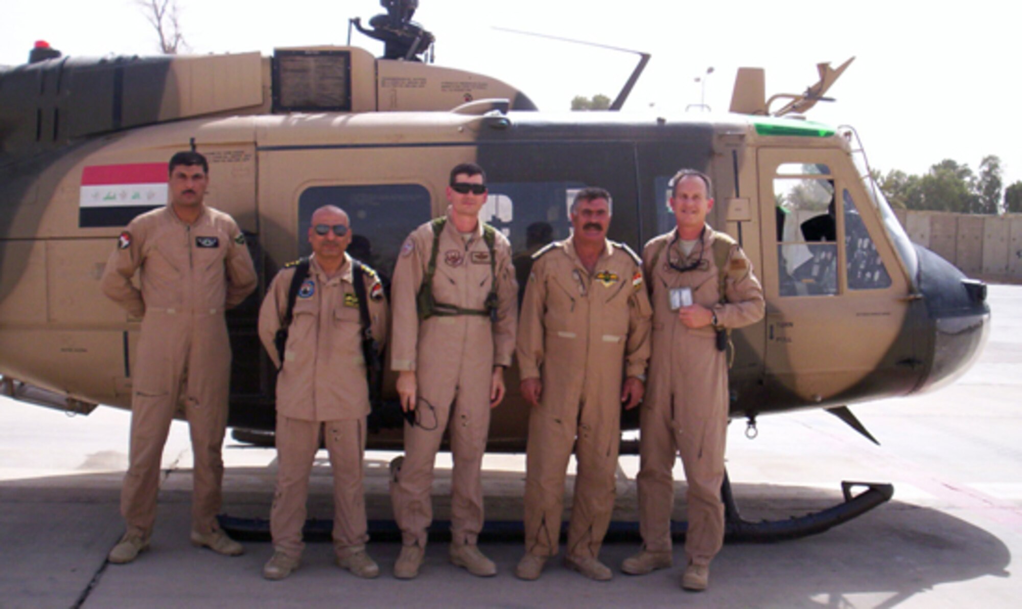 Lt. Col. David Smith (far right), 412th Test Management Group deputy from Edwards, and Lt. Col. Andrew Hostetter (middle), from Wright-Patterson Air Force Base, Ohio, pose for a photo with Iraqi air force airmen. Colonels Smith and Hostetter, who are currently deployed to Southwest Asia, helped the IAF coordinate an air escort mission providing defense and deterrence support for Iraq Prime Minister Nouri Maliki. (Courtesy photo)
