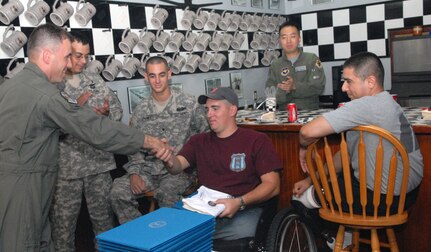 Maj. Craig Jasper, 559th Flying Training Squadron Wings for Wounded Warriors project officer, thanks Eric Horton for his service. Thirteen wounded warriors who are currently receiving care at the Center for the Intrepid at Brooke Army Medical Center in San Antonio, joined base leaders for a VIP tour of Randolph AFB to learn about the 12th Flying Training Wing mission. (U.S. Air Force photo by Rich McFadden)