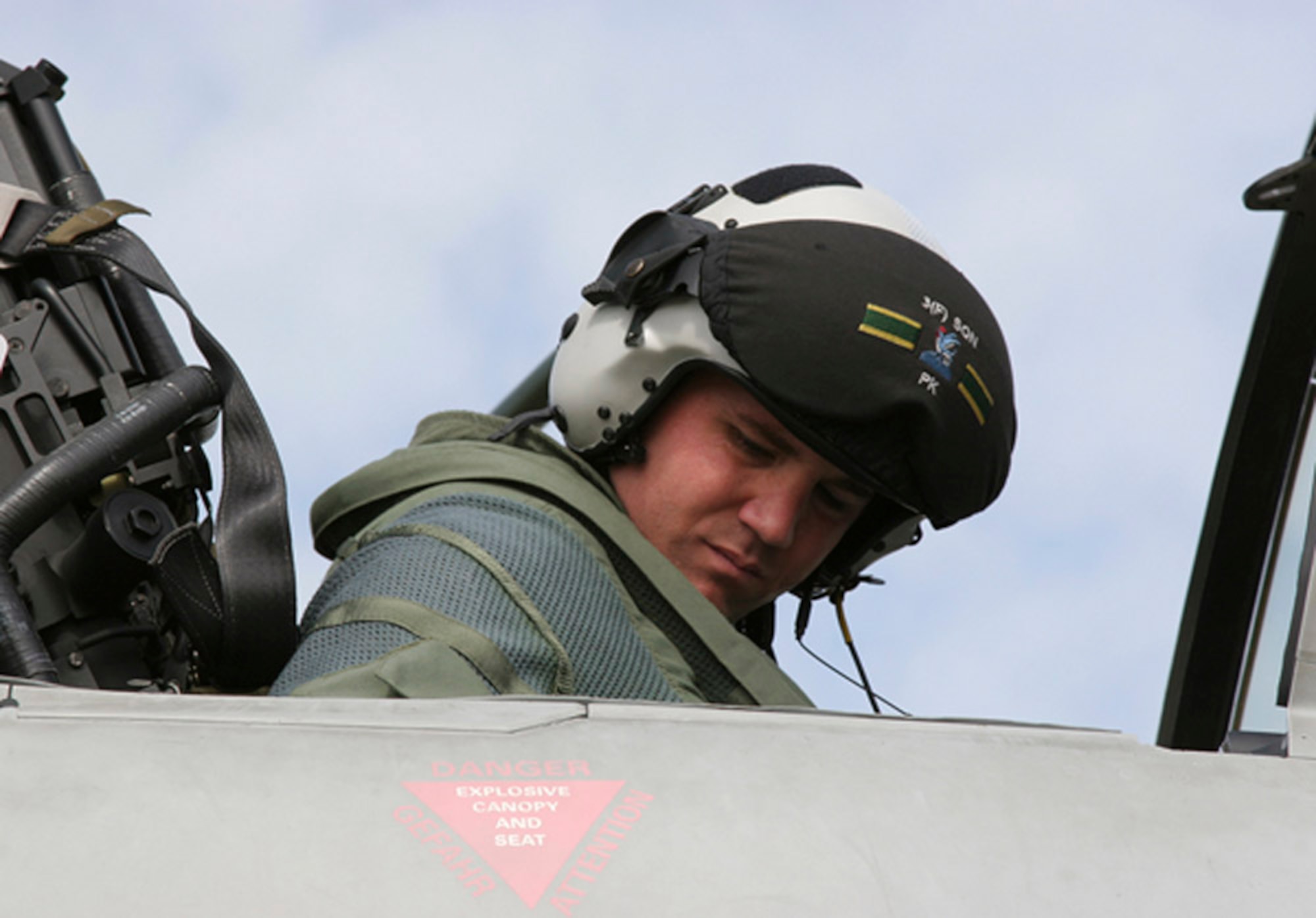 Maj. Paul Carlton straps himself into an F-2 Typhoon June 16 at Royal Air Force Coningsby, England. Major Carlton is an F-16 Fighting Falcon pilot on an exchange program. (Courtesy photo)