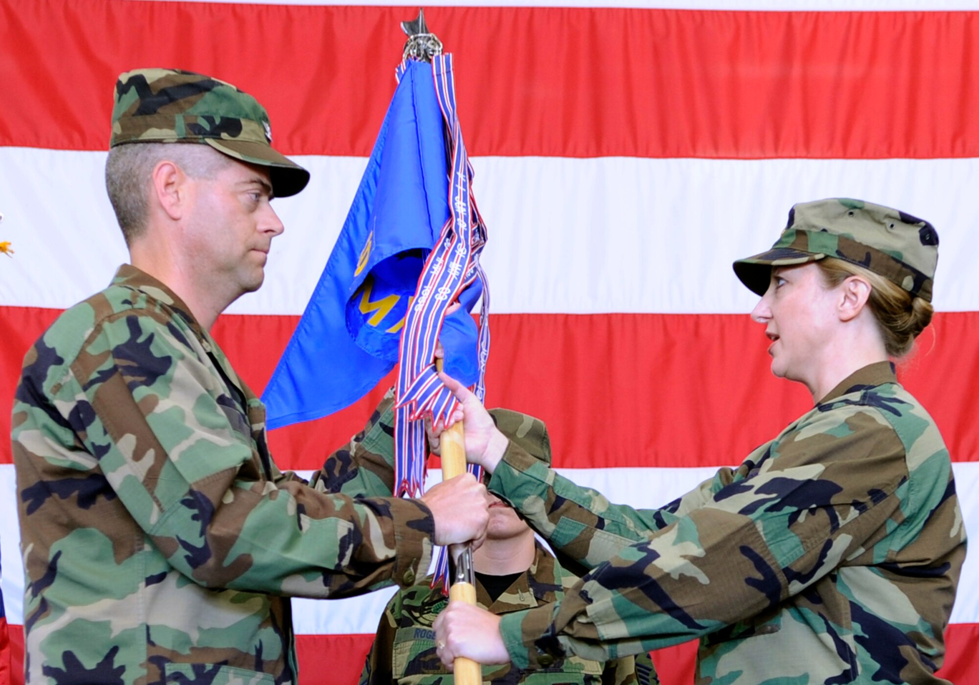 Maj. Carolyn Forner (right), assumes command of the 28th Aircraft Maintenance Squadron by accepting the guidon from Col. Thomas Fitch (left), 28th Maintenance Group commander during a change of command ceremony, here, June 30. Major Forner comes from Air Command and Staff College in Maxwell Air Force Base, A.L.(U.S. Air Force photo/Airman 1st Class Kasey Zickmund)