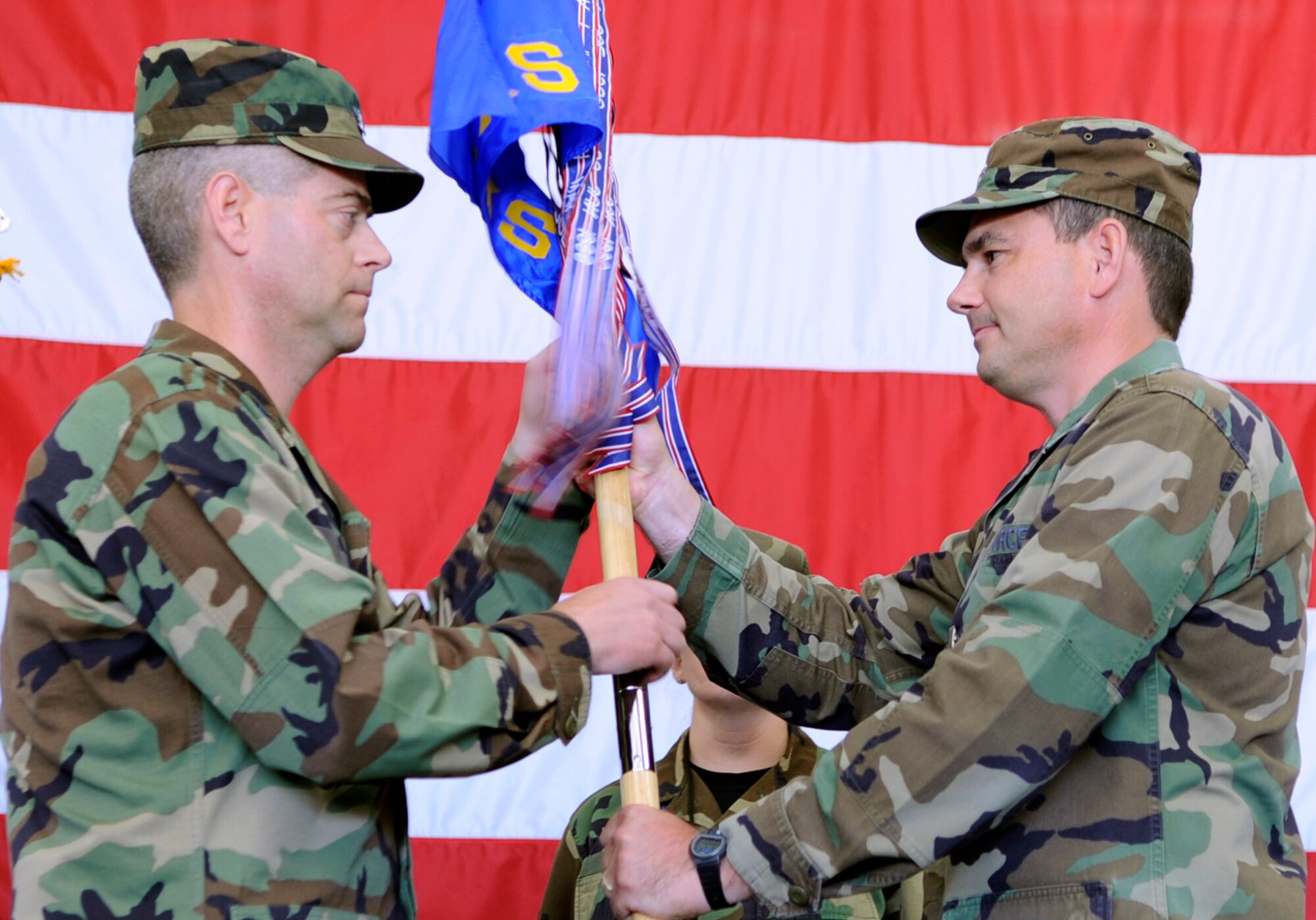 Lt. Col. David Stimac (right), 28th Aircraft Maintenance Squadron commander, relinquishes command by passing the guidon to Col. Thomas Fitch (left), 28th Maintenance Group commander, during a change of command ceremony, here, June 30. Colonel Stimac will be the 49th Maintenance Group deputy commander at Holloman Air Force Base, N.M.(U.S. Air Force photo/Airman 1st Class Kasey Zickmund)