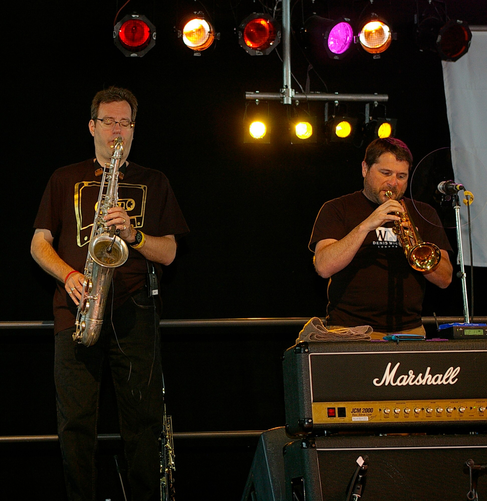 Mitch Paliga (left) on the saxophone and Kirk Garrison on trumpet, play for the audience June 29 at the Lt. Dan Band concert at RAF Mildenhall.  The band was here as part of a United Services Organization tour, playing to servicemembers around the world to show their support for them. Approximately 650 people watched the concert as the Lt. Dan Band interacted with the crowd and kept everyone entertained for the two-hour show. (U.S. Air Force photo by Karen Abeyasekere)