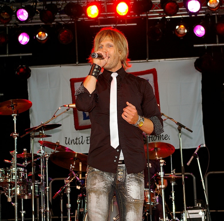 Jeff Vezain, lead vocalist with the Lt. Dan Band, sings Rob Thomas and Santana's "Smooth" to the crowd at RAF Mildenhall June 29. The band was here as part of a United Services Organization tour, playing to servicemembers around the world to show their support for them. Approximately 650 people watched the concert as the Lt. Dan Band interacted with the crowd and kept everyone entertained for the two-hour show. (U.S. Air Force photo by Karen Abeyasekere)