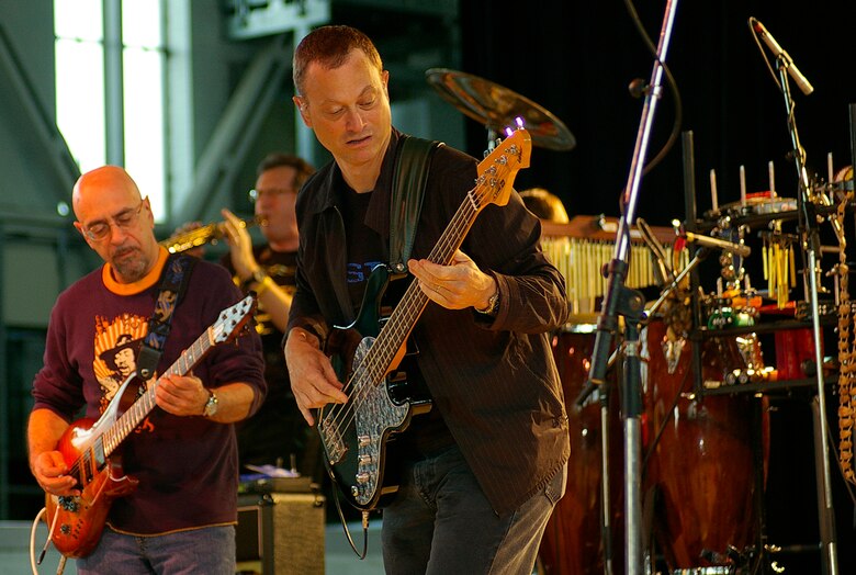 Ernie Denov (left) plays guitar alongside actor and bassist Gary Sinise (right) during a Lt. Dan Band concert at RAF Mildenhall June 29. The band was here as part of a United Services Organization tour, playing to servicemembers around the world to show their support for them. Approximately 650 people watched the concert as the Lt. Dan Band interacted with the crowd and kept everyone entertained for the two-hour show. (U.S. Air Force photo by Karen Abeyasekere)