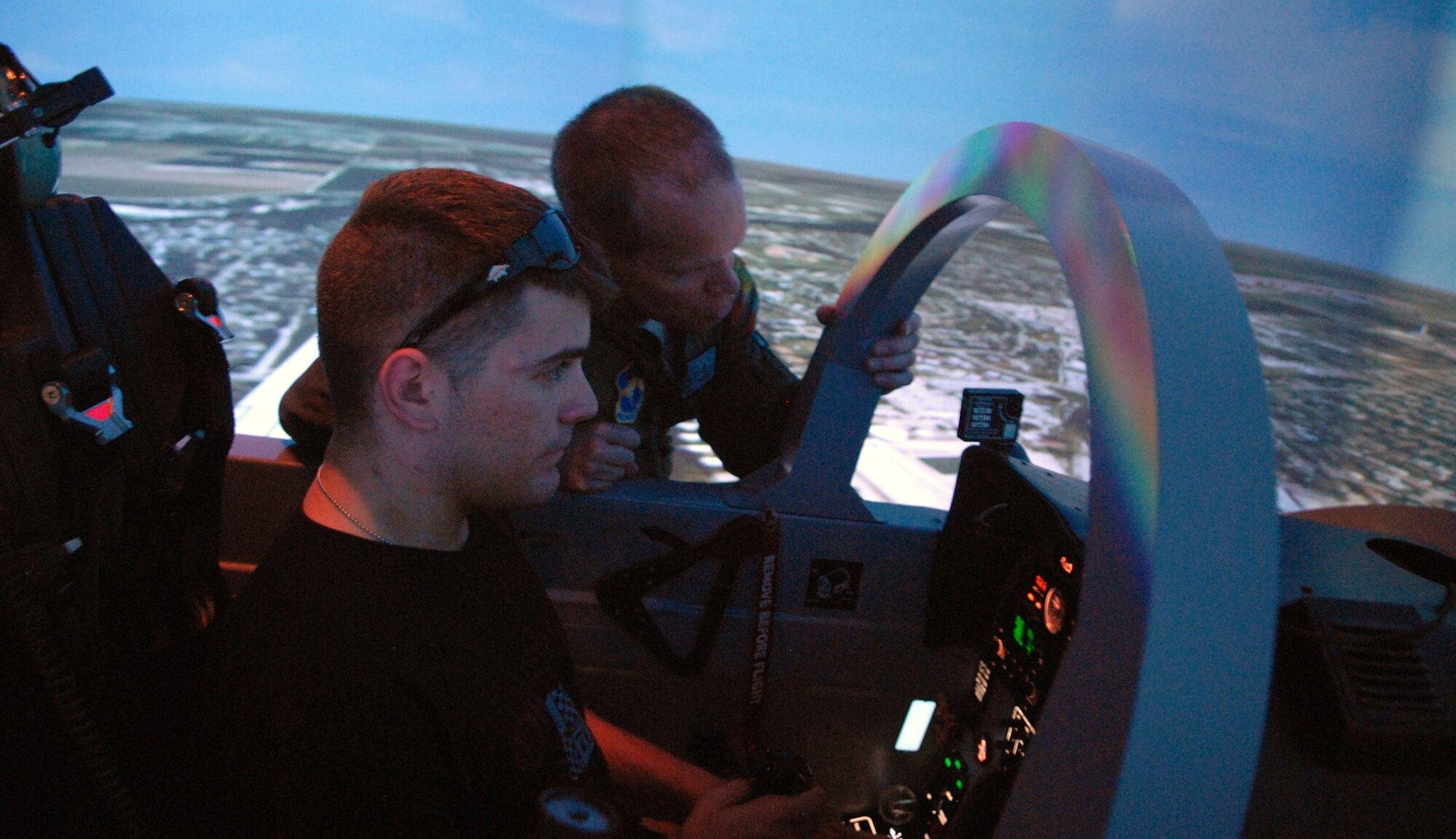 Matt Poirier mans the controls of a T-6A Texan II flight simulator during a June 27 tour of Randolph Air Force Base, Texas, June 27. Mr. Poirer, a wounded war veteran, and 12 other wounded warfighters recovering from serious injuries toured the base and flew a simulator at the 559th Flying Training Squadron. The wounded warriors are currently receiving care at the Center for the Intrepid at Brooke Army Medical Center in San Antonio. (U.S. Air Force photo/Rich McFadden) 
