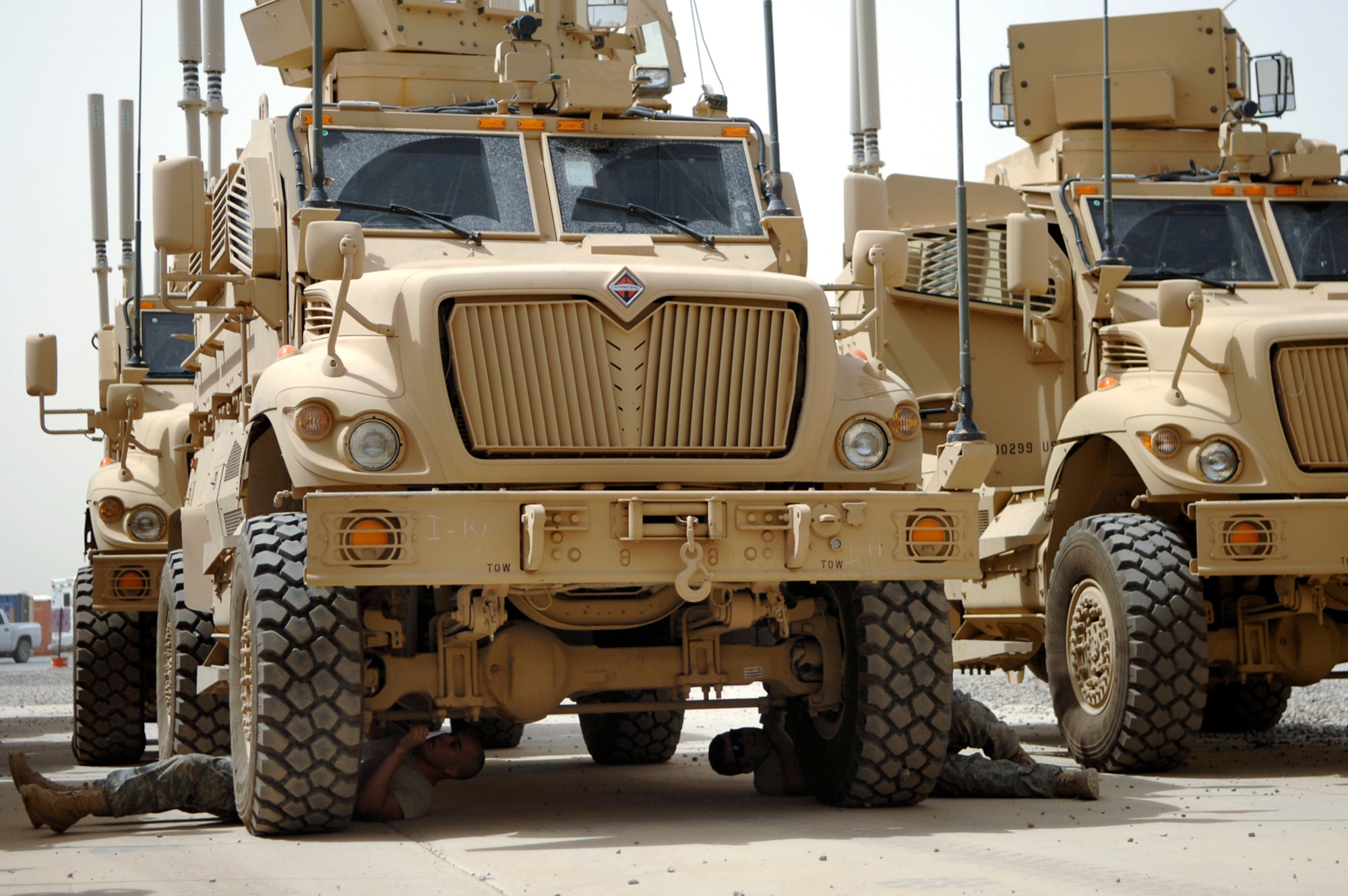 JOINT BASE BALAD, Iraq -- Airman 1st Class Jared Lucci and Staff Sgt. Gabriel Foster, 332nd Expeditionary Logistics Readiness Squadron vehicle maintainers, checks the undercarriage of a Mine Resistant Ambush Protected armored vehicle during an acceptance limited technical inspection here, June 28. The inspection ensures that all the systems and equipment on the vehicle are in working order before issuing it out to various units. Airman Lucci is deployed from McGuire Air Force Base, N.J., and Sergeant Foster is deployed from Hill Air Force Base, Utah. (U.S. Air Force photo/ Senior Airman Julianne Showalter)