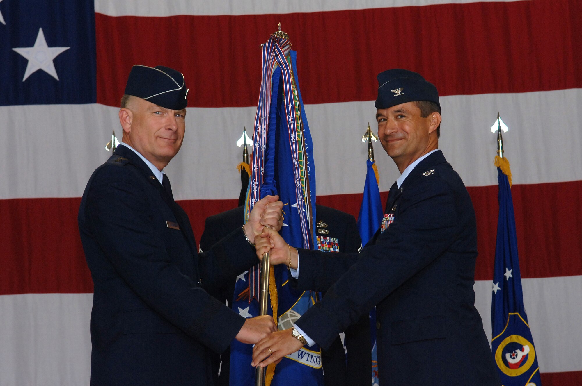 United States Air Force Maj. Gen. Jack Egginton, commander, 3rd Air Force, passes the 435th Air Base Wing guidon to Col. Donald Bacon, commander, 435th ABW, during Col. Bacon's assumption of command ceremony, Ramstein Air Base, Germany, July 1, 2008. (US Air Force Photo by Airman 1st Class Tony R. Ritter)(Released)