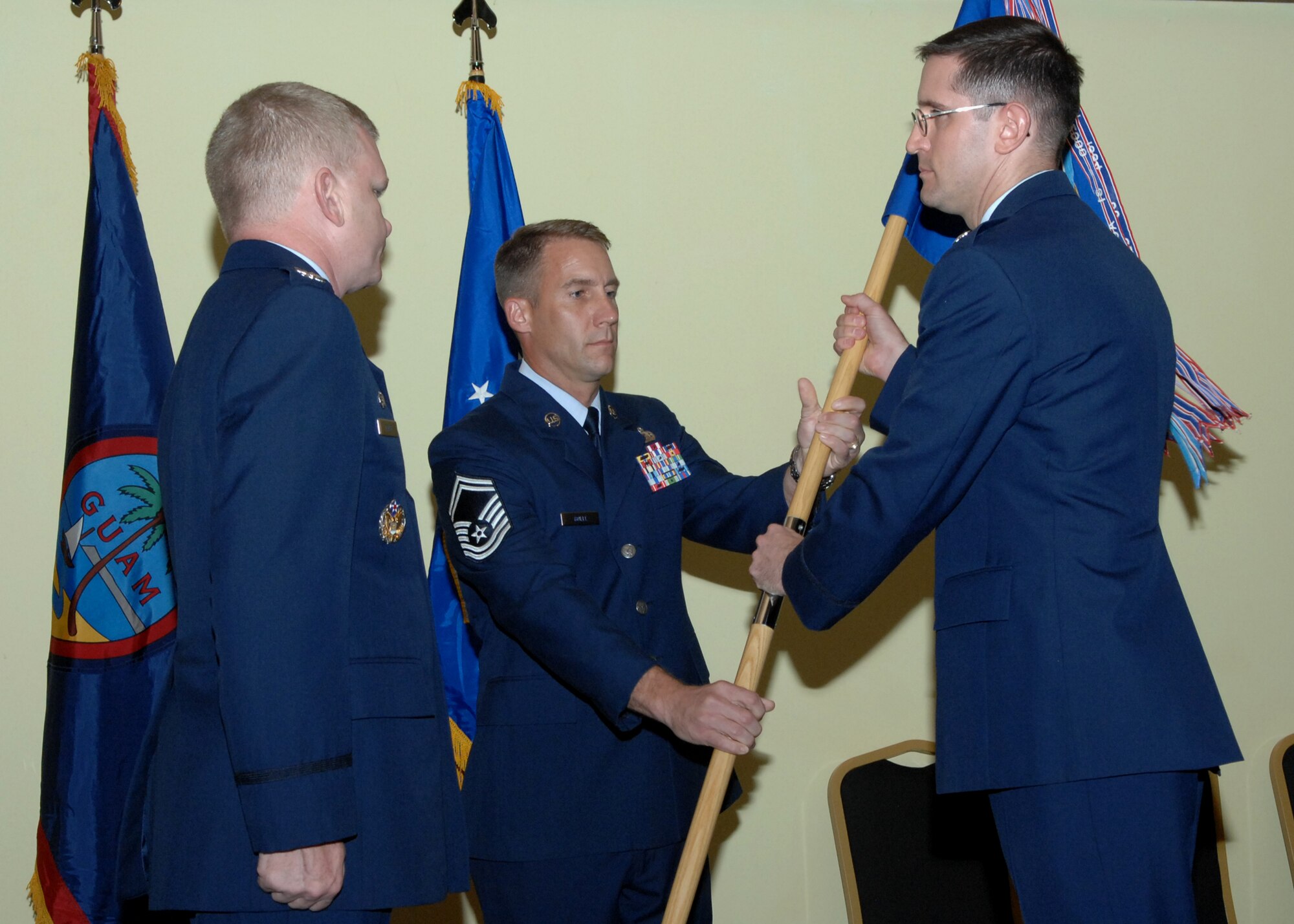 Col. Paul Nosek 36th Mission Support Squadron commander, receives the 36th MSS guidon before passing it to Col. Mark Talley 36th Mission Support Group commander signifying the deactivation of the squadron July 1 here. The 36th Services Squadron and the 36th MSS were both deactivated and merged together creating the 36th Force Support Squadron.(U.S. Air Force by Airman 1st Class Nichelle Griffiths) 
