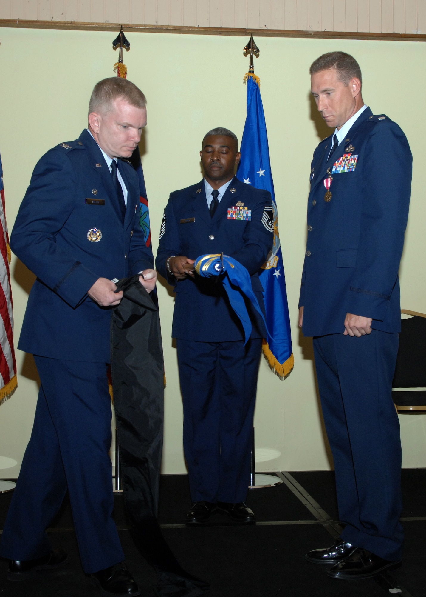 Col. Mark Talley 36th Mission Support Group commander and Lt. Col. Alex Gaines 36th Serivces Squadron commander case the 36th SVS guidon signifying the deactivation of the squadron July 1 here. The 36th SVS and the 36th Mission Support Squadron were both deactivated and merged together creating the 36th Force Support Squadron.(U.S. Air Force by Airman 1st Class Nichelle Griffiths) 