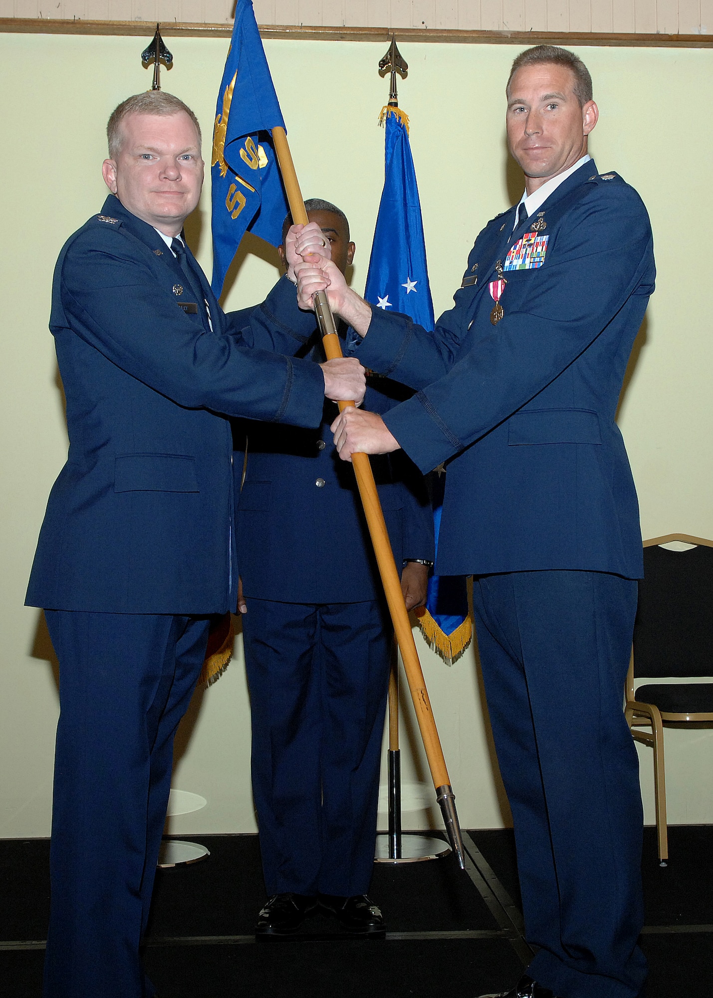 Lt. Col. Alex Gaines 36th Serivces Squadron commander passes off the 36th SVS guidon to Col. Mark Talley 36th Mission Support Group commander relinquishing command and deactivation the squadron July 1 here. The 36th SVS and the 36th Mission Support Squadron were both deactivated and merged creating the 36th Force Support Squadron.(U.S. Air Force by Airman 1st Class Nichelle Griffiths) 