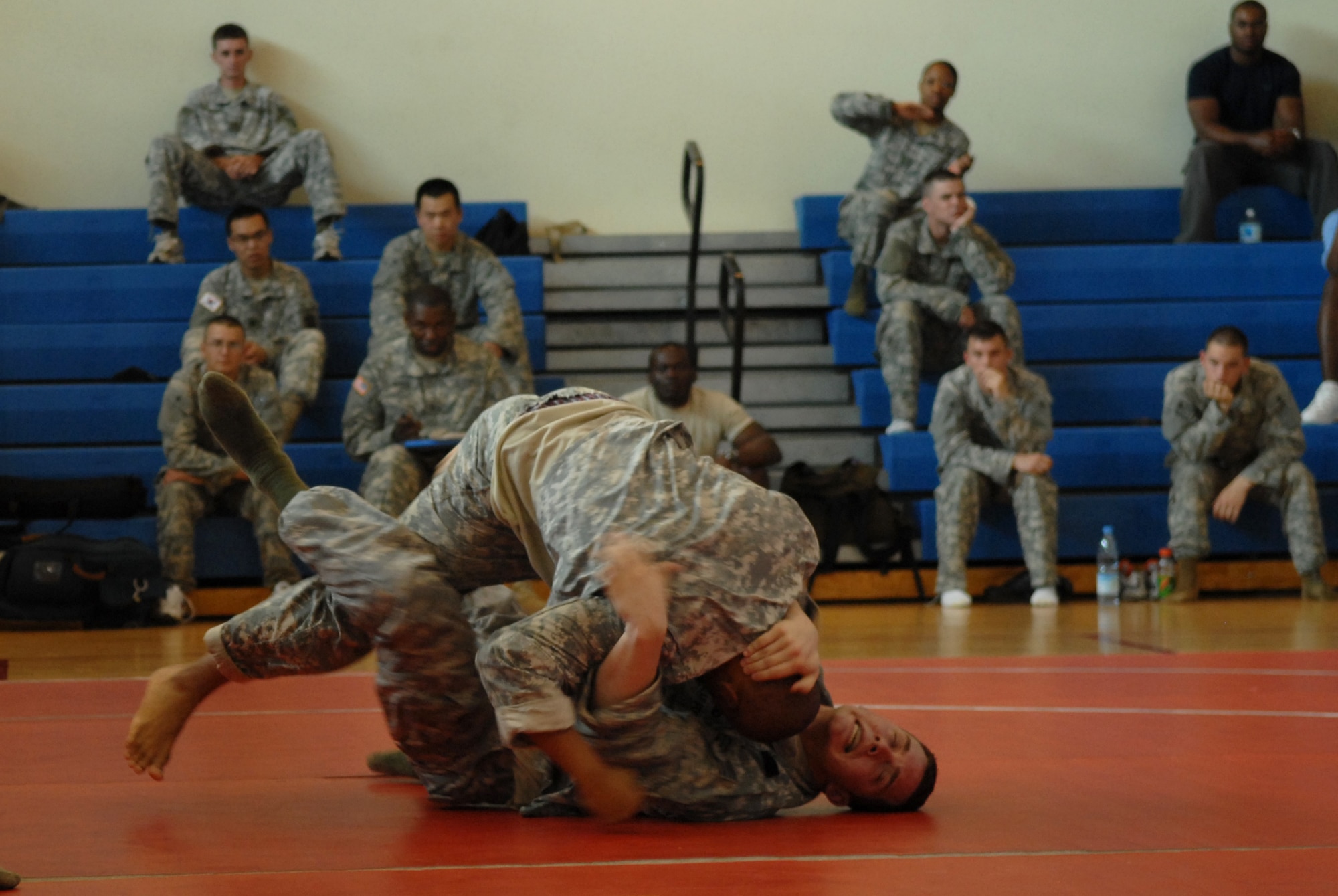 Army Spc. Derrick Royal,  Charlie / 1-44th Battalion, uses the techniques learned from during combative training to compete against  Staff Sgt. Dustin Rieber, 8th Security Forces Squadron, here June 27.  Specialist Royal and Sergeant Rieber have completed Level one of Modern Army Combative Training, a  hand-to-hand combat training, teaching self-defense techniques from several different  martial arts and combat sports required for all Soldiers and optional for Airmen.(US Air Force Photo by: Senior Airman Angela Ruiz)