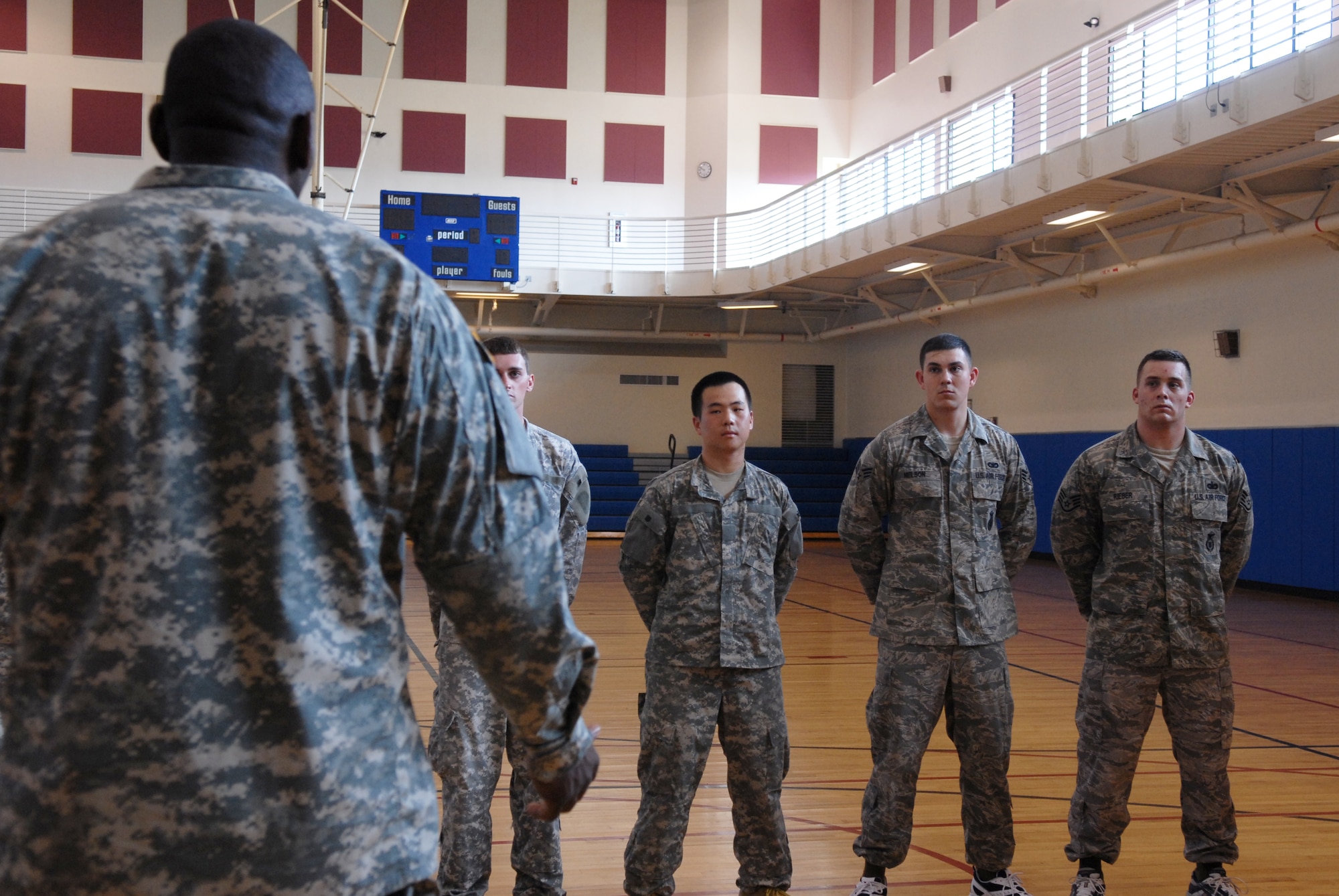 Staff Sgt. Dustin Rieber, Senior Airman Brandon Nelson, 8th Security Forces Squadron,  Army PFC Jinho Im, Charlie / 1-44th Battalion, along with other students in the  level one Modern Army Combative Training course listen to 1st Lt. Rashaun Warren, Charlie / 1-44th Battalion,  here June 27. The Modern Army Combative Training is hand to hand combat training, teaching Solders and Airmen self-defense techniques from several different  martial arts and combat sports.(US Air Force photo by: Senor Airman Angela Ruiz)