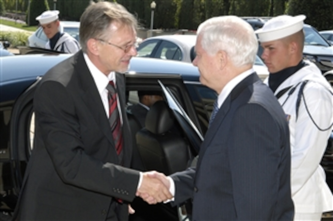 U.S. Defense Secretary Robert M. Gates, right, greets Lithuanian Prime Minister Gediminas Kirkilas at the Pentagon's river entrance prior to escorting him through an honor cordon to conduct a closed-door discussion of bilateral issues, July 1, 2008.  