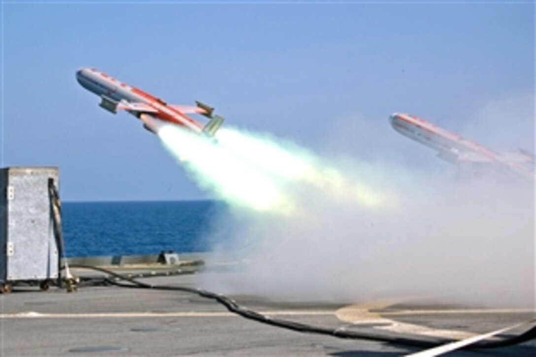 One drone is launched next to another from the U.S. Navy's amphibious dock landing ship USS Tortuga during a scheduled missile exercise, in Singapore, June 26, 2008. The drone was shot down with a missile launched from the Republic of Singapore ship RSS Endeavour as part of Cooperation Afloat Readiness and Training. CARAT is an annual series of maritime training exercises between the United States and six Southeast Asian nations.
