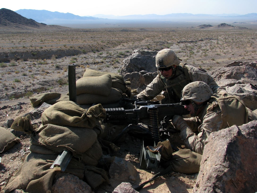 Lance Cpl. Francis Grenham, an Echo Company machine gunner from Dedham, Mass., employs his M240B machine gun in support of a platoon attack during a live-fire training exercise here July 1, 2008.   Grenham is assisted by his team leader, Cpl. Keith Anderson.  A junior at Southern Maine University and an environmental science major, Grenham intends to serve overseas in the U.S. Peace Corps after completing his reserve commitment and graduating from the university.  Anderson, a Millersville, Pa. native, is a construction contractor headed for his second tour in Iraq.