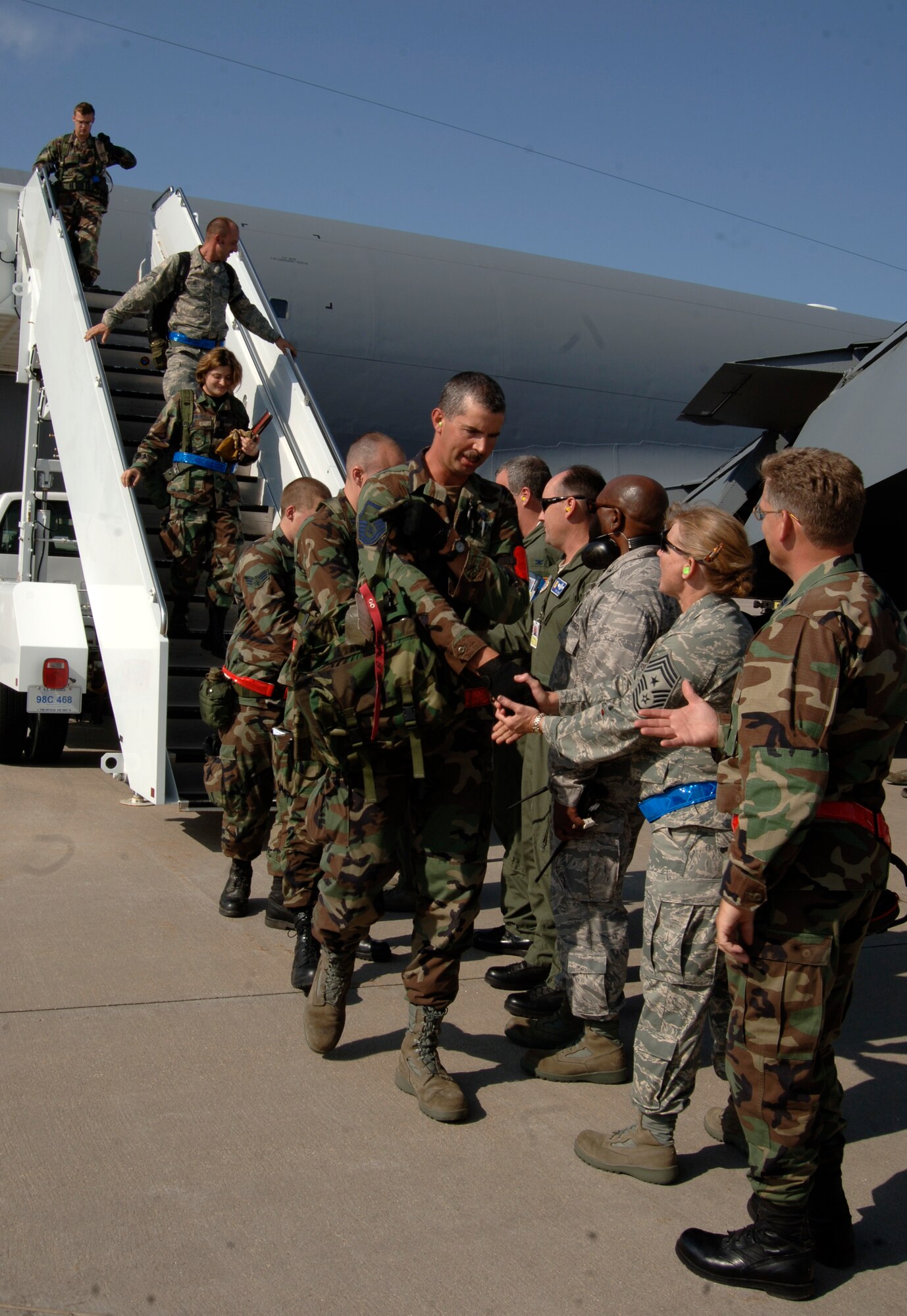 MCCONNELL AIR FORCE BASE, Kan. -- McConnell Air Force Base returning personnel file through the line of greeting Airmen upon their return from the Operational Readiness Inspection, June 28. The personnel deployed to Volk Field for a week in order to test their capability to perform their required duties. (Photo by Airman Justin Shelton)