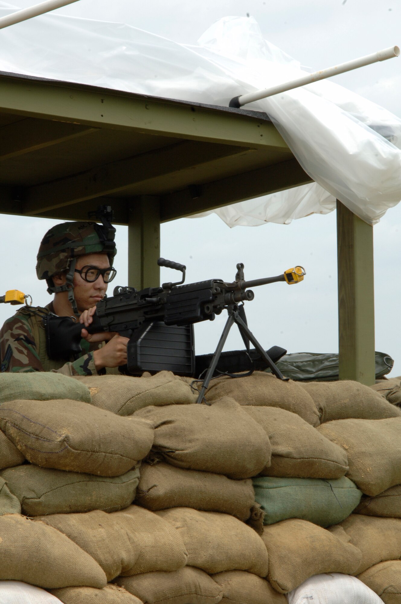 VOLK FIELD AIR NATIONAL GUARD BASE, Wis. -- Senior Airman John Osborne, 804th Security Forces Squadron, performs guard duty in a defensive fighting position at Volk field, Wis., June 25. Airman Osborne, along with his night-shift counterpart, must maintain a 24-hour watch over the base to protect against any hostile acts. (photo by Senior Airman Laura Suttles)
