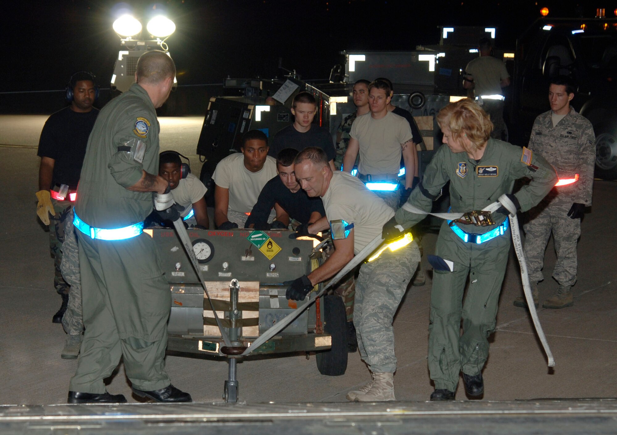 MCCONNELL AIR FORCE BASE, Kan. -- Team McConnell members load equipment on a KC-135 Stratotanker on the flight line, June 24, in preparation for an Operational Readiness Inspection. The Inspector General team placed members in scenarios to test their abilities to survive and operate in contingency operations during the ORI. (Photo by Senior Airman Roy Lynch III)