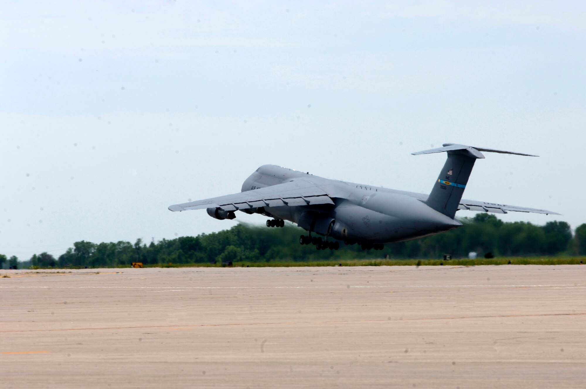 MCCONNELL AIR FORCE BASE, Kan. -- A C-5 Galaxy from Dover Air Force Base, De. departs the flight line with Team McConnell members, June 23. The C-5 transported its passengers to Volk Field, Wis. for an Operational Readiness Inspection before returning to McConnell for a second trip. (Photo by Airman Justin Shelton)