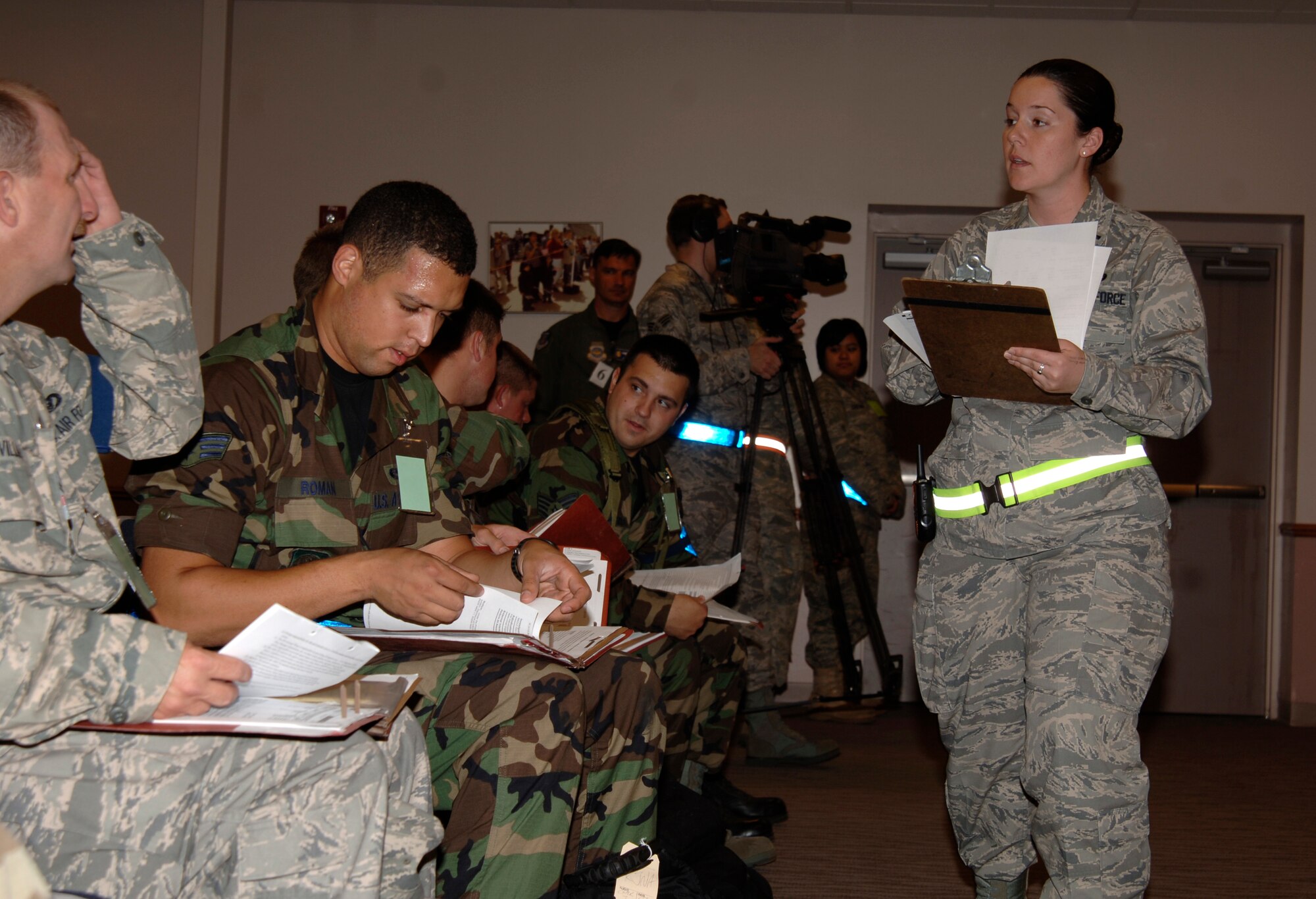 MCCONNELL AIR FORCE BASE, Kan. -- First Lieutenant Moira Tracy, 22nd Mission Support Squadron, briefs Team McConnell members prior to their processing through the personnel deployment function line, June 23. Lieutenant Tracy worked with a team of Airmen to efficiently process multiple chalks of personnel. (Photo by Airman Justin Shelton)