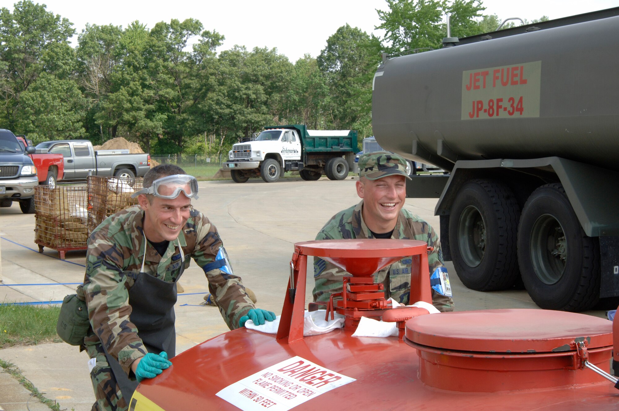 VOLK FIELD AIR NATIONAL GUARD BASE, Wis. -- Airman 1st Class Matt Cavazos and Staff Sergeant Joshua Tuck, 804th Logistics Readiness Squadron, push a portable tank filled with fuel at Volk Field, Wis., June 25. The Airmen of the Petroleum, Oils, and Lubricant flight are in charge of getting fuel to the KC-135 Stratotanker so they may complete their mission: refueling. (photo by Senior Airman Laura Suttles)