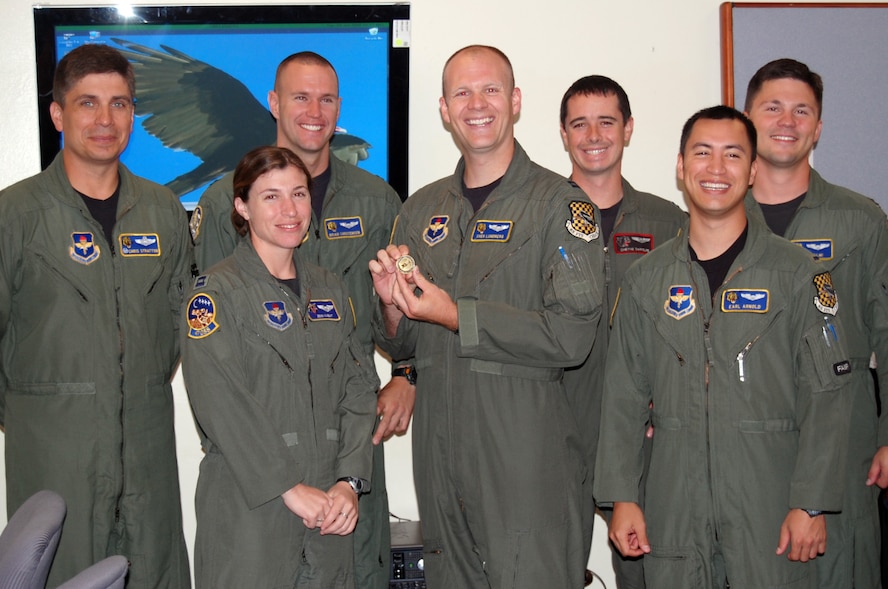 LAUGHLIN AIR FORCE BASE, Texas – Capt Sven Lundberg, 85th Flying Training Squadron, shows off his XLer award coin with fellow employees after the presentation of the coin July 1 by Col. John Doucette, 47th Flying Training Wing commander. (U.S. Air Force photo by Staff Sgt. Olufemi A. Owolabi)