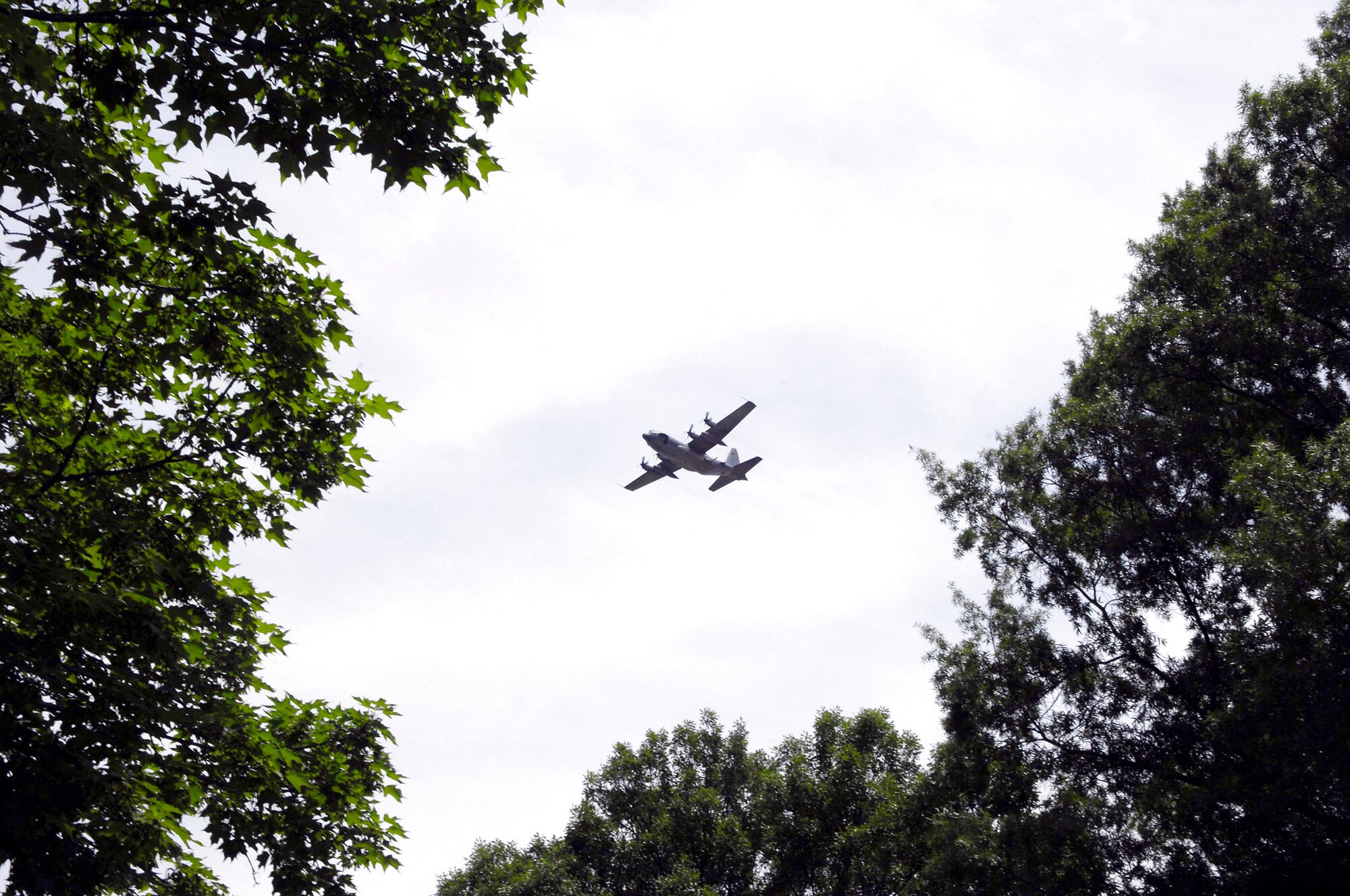 An AC-130H Spectre gunship from the 16th Special Operations Squadron conducts a flyover at Arlington National Cemetary during a memorial service for Senior Master Sgt. James Caniford May 28. Sergeant Caniford, a former 16th SOS illuminator operator, was recently identified after more than 30 years listed as missing in action from the Vietnam War. (U.S. Air Force photo/Senior Airman Marleah Miller) 
