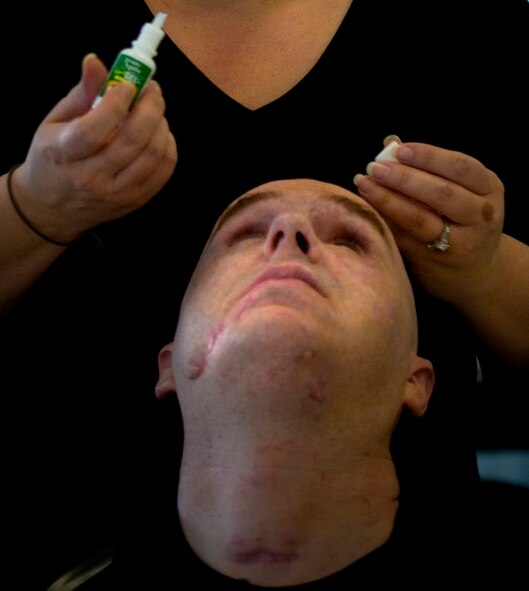 Annette has become somewhat of an expert at putting drops in her husband's eye after having to do so for at least every hour 24 hours a day, for four weeks straight.(photo by Tech. Sgt. Matthew Hannen)