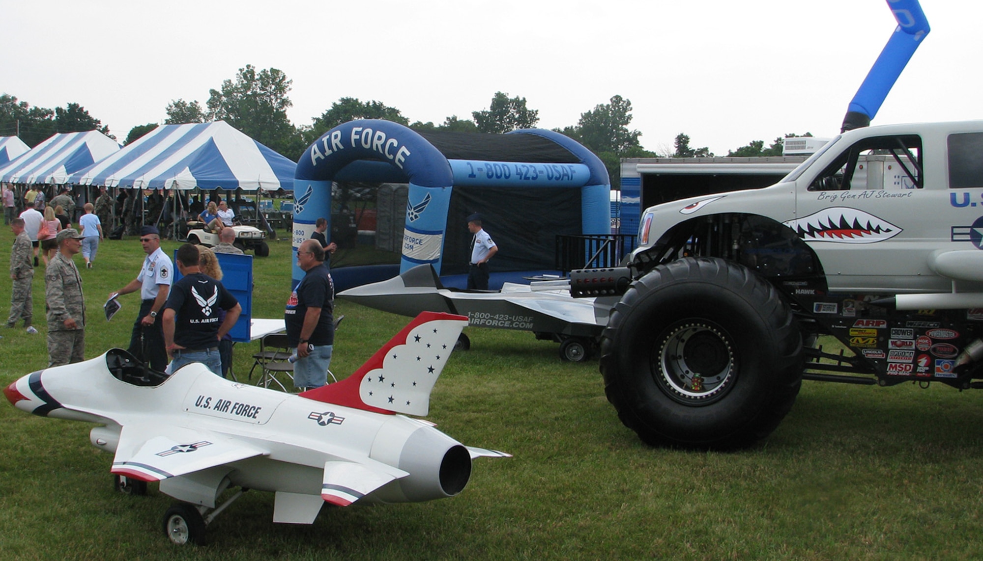 Members of the 338th Recruiting Squadron put the finishing touches on their display area at the Air Force Material Command’s fourth annual “Freedom’s Call” Military Tattoo June 27 at Wright-Patterson AFB, Ohio. Recruiters at the event shared information about Air Force job opportunities with some of the 80,000 curious spectators. (U.S. Air Force photo/Capt. John Green)