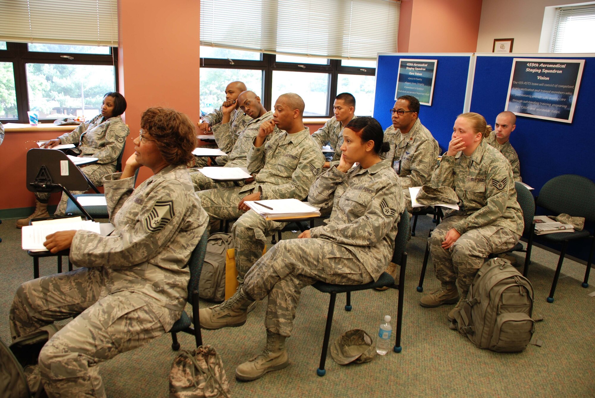 ANDREWS AIR FORCE BASE, Md. -- Members of the 459th Aeromedical Staging Squadron listen to briefings upon their return from Ali Al Salem Air Base, Kuwait, in May. The unit directly participated in the rescue of passengers and drivers when three buses collided approximately one half mile outside the main gate of the base. (U.S. Air Force photo/Tech. Sgt. Amaani Lyle)