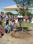 Members of Team Lackland celebrate Arbor Day by planting a tree at the new youth center May 19, 2008. Lackland has been observing the Arbor Day tradition since its designation as a Tree City USA community by the National Arbor Day Foundation in 1993. (USAF photo by Meredith Canales)