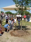 Members of Team Lackland celebrate Arbor Day by planting a tree at the new youth center May 19, 2008. Lackland has been observing the Arbor Day tradition since its designation as a Tree City USA community by the National Arbor Day Foundation in 1993. (USAF photo by Meredith Canales)