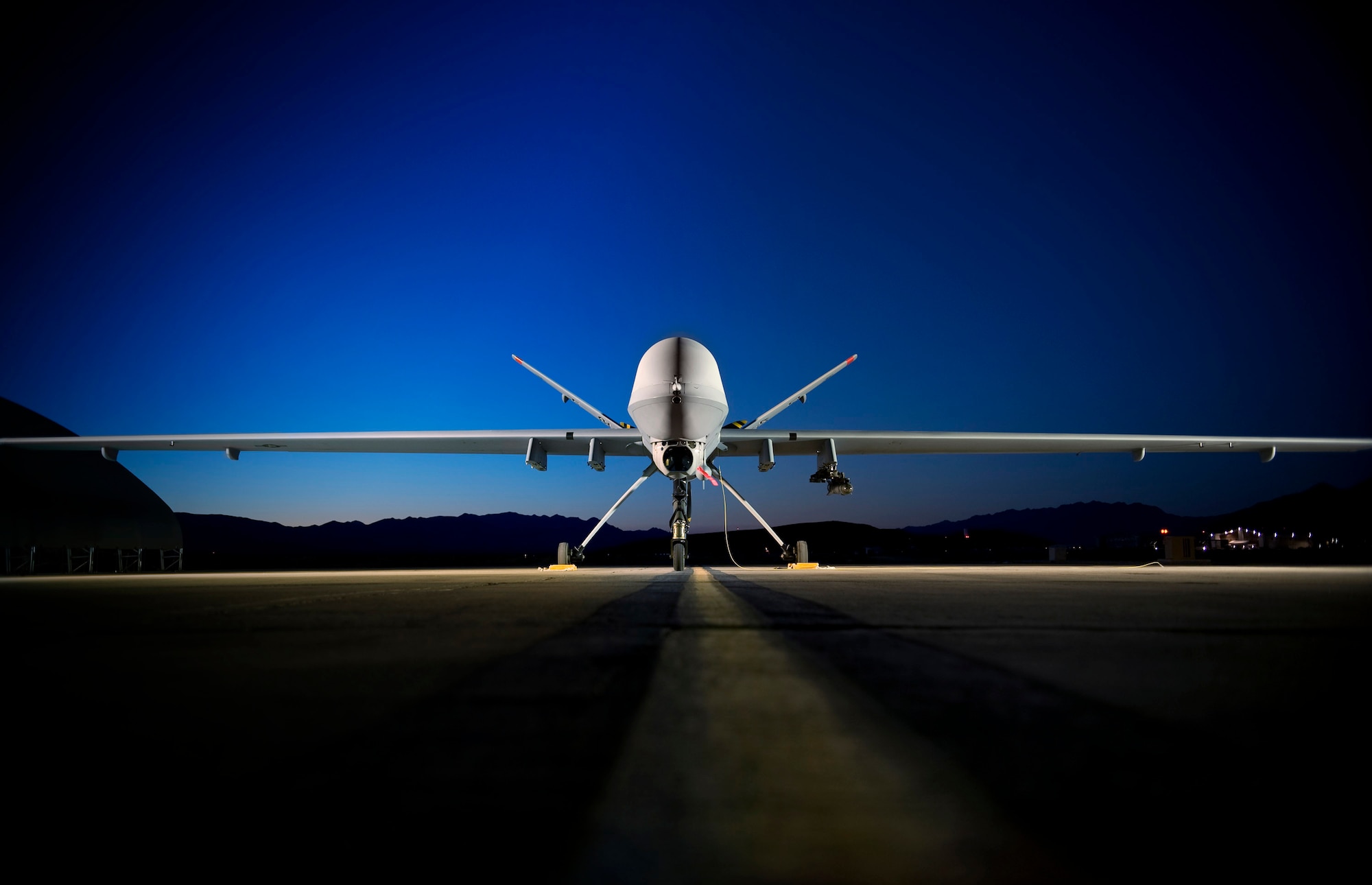 An MQ-9 Reaper sits on the flightline at Creech Air Force Base, Nev. June 19. The Reaper is capable of carrying both precision-guided bombs and air-to-ground missiles. Gen. John D.W. Corley, Air Combat Command commander, met with Army Gen. William S. Wallace, Army Training and Doctrine Command commanding general, June 30 to discuss a new concept of operations that would maximize the contributions unmanned aerial systems bring to the joint warfighter. (U.S. Air Force photo/Lance Cheung)