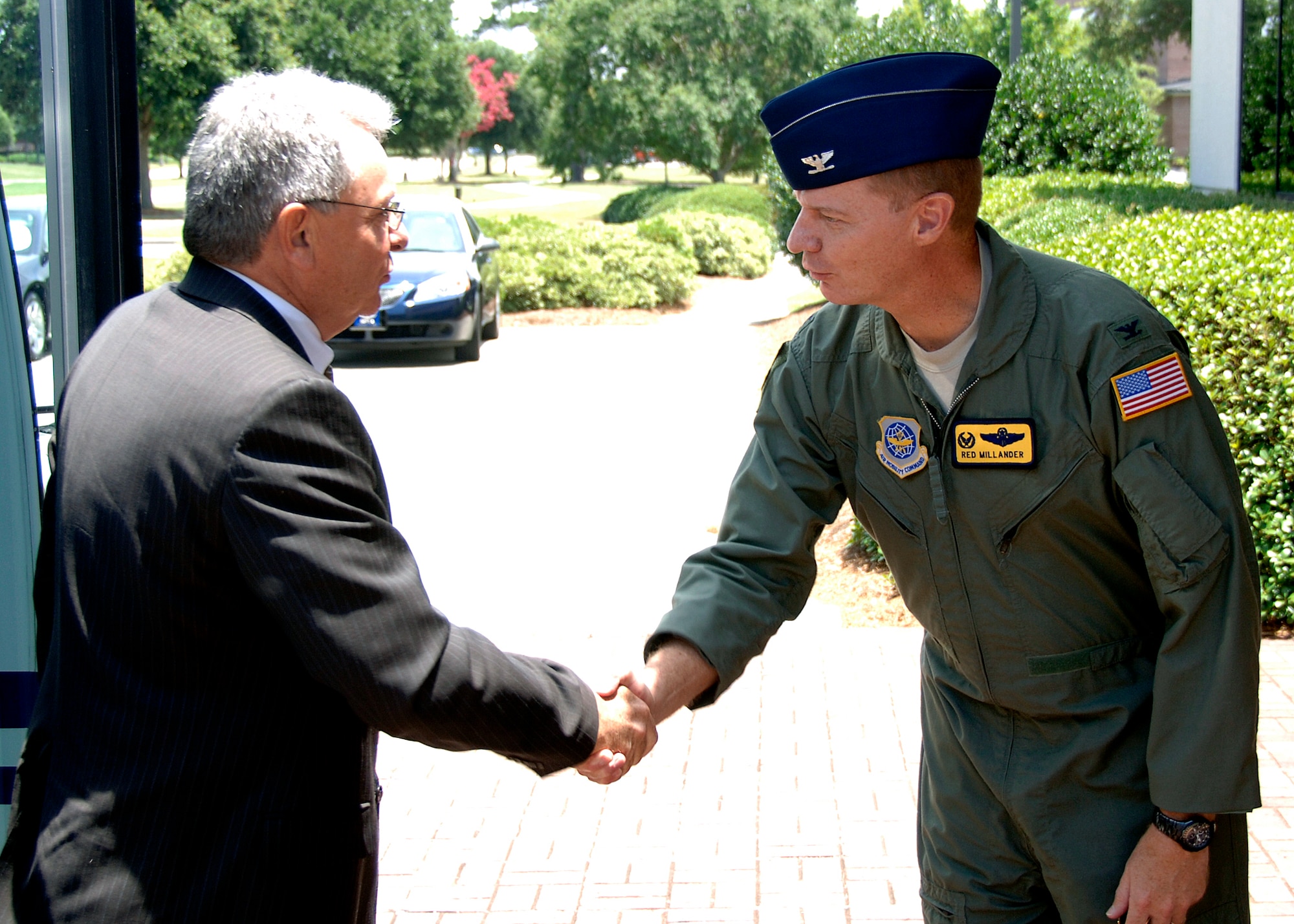 Col. John "Red" Millander greets Jean-Robert Cazarre at the wing headquarters building July 1 as part of a European Organization for the Safety of Air Navigation visit. The purpose of Mr. Cazarre's visit was to observe how the Charleston community integrates its military and civilian airport and airfield management operations to benefit both operations. Colonel Millander is the 437th Airlift Wing commander and Mr. Cazarre is the director for the directorate of Civil and Military Air Traffic Management for EUROCONTROL. (U.S. Air Force photo/Airman 1st Class Timothy Taylor)
